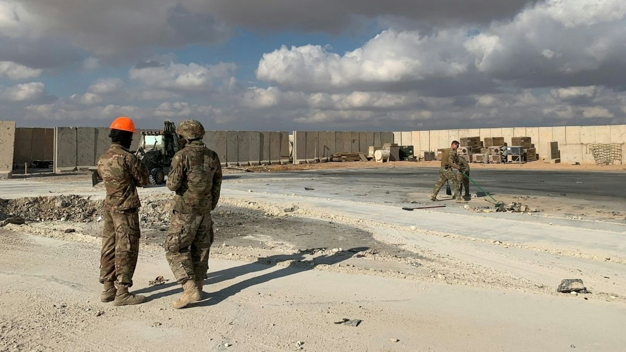 A picture taken on January 13, 2020 during a press tour organised by the US-led coalition fighting the remnants of the Islamic State group, shows US soldiers clearing rubble at Ain al-Asad military airbase in the western Iraqi province of Anbar.