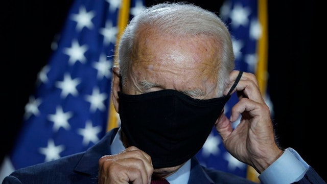 Presumptive Democratic presidential nominee former Vice President Joe Biden puts his mask back on after delivering remarks following a coronavirus briefing with health experts at the Hotel DuPont on August 13, 2020 in Wilmington, Delaware.