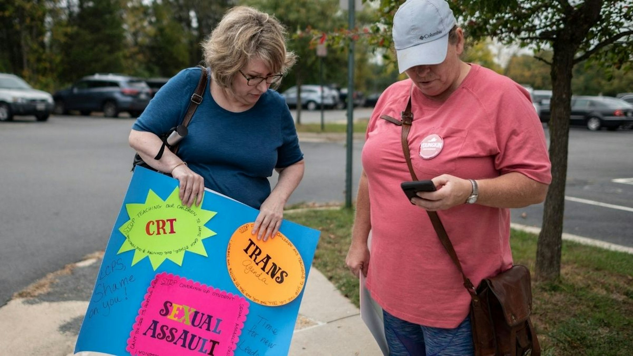 Protesters and activists stand outside a Loudoun County Public Schools (LCPS) board meeting in Ashburn, Virginia on October 12, 2021.