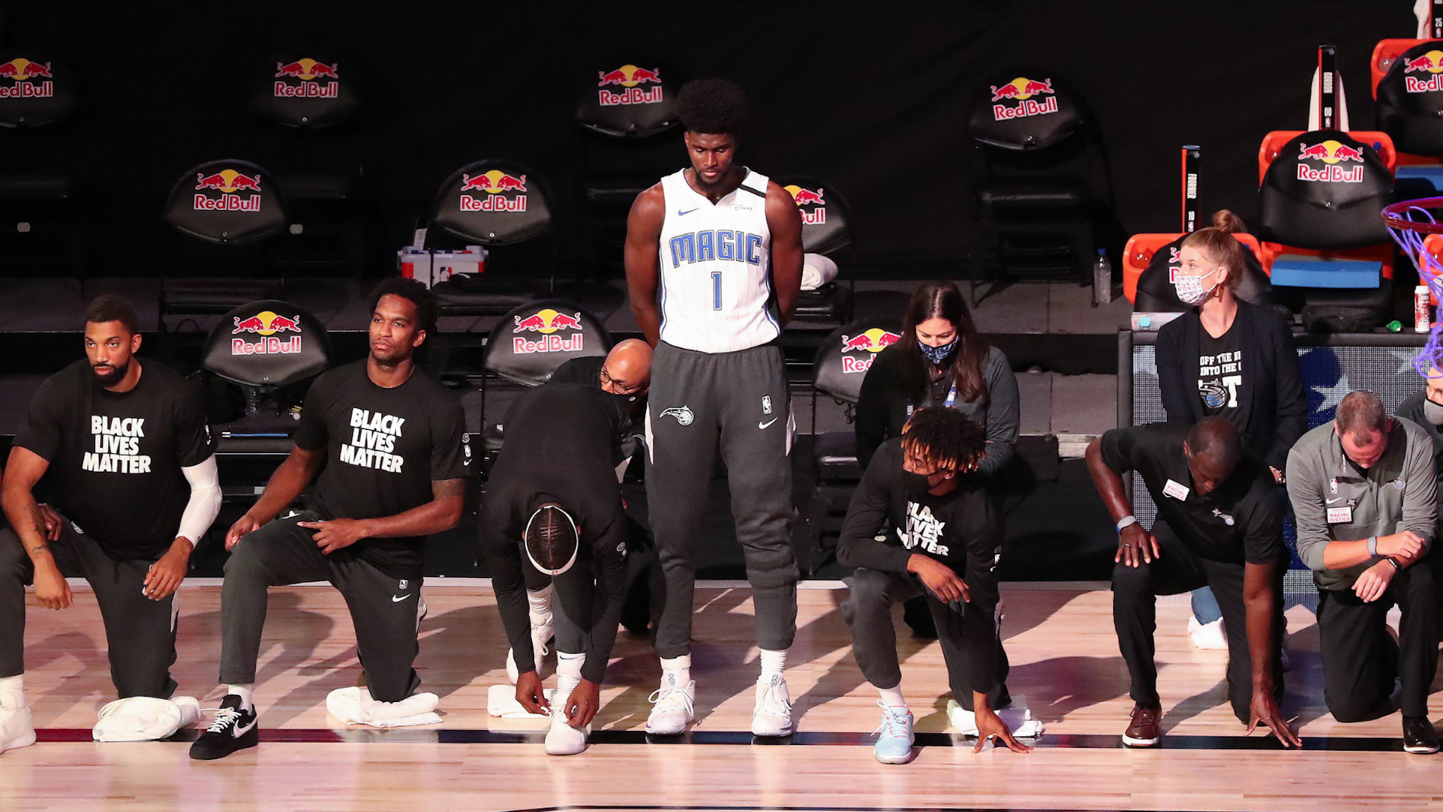 Orlando Magic forward Jonathan Isaac (1) is the lone player to stand and not wear a "Black Lives Matter" t-shirt prior to a game against the Brooklyn Nets at Disney's Wide World of Sports' HP Field House in Lake Buena Vista, Florida, on Friday, July 31, 2020.