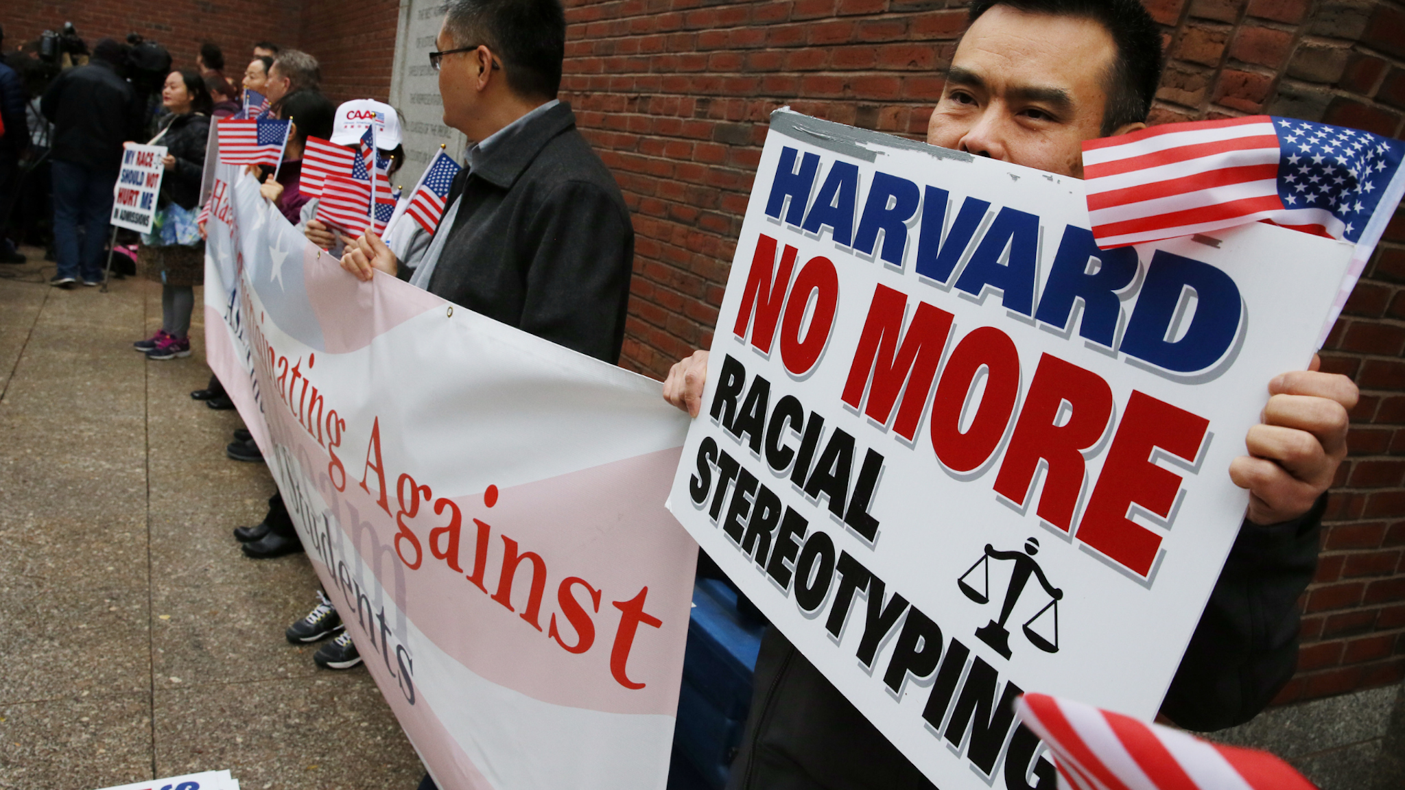 Jia Wu joins protestors during a press conference held by Harvard attorneys following closing arguments in the Harvard admissions trial at the the John Joseph Moakley United States Courthouse in Boston on Nov. 2, 2018. Harvard University quietly changed significant portions of its training manual for admissions officers this year, addressing some of the key issues at the heart of an ongoing federal trial over whether the school discriminates against Asian-American applicants.