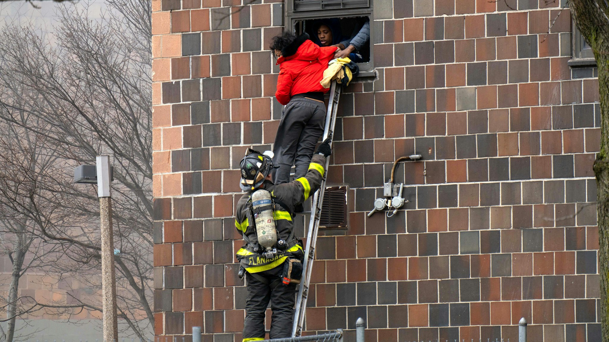 Firefighters hoisted a ladder to rescue people through their windows after a fire broke out inside a third-floor duplex apartment at 333 E. 181st St. in the Bronx Sunday.