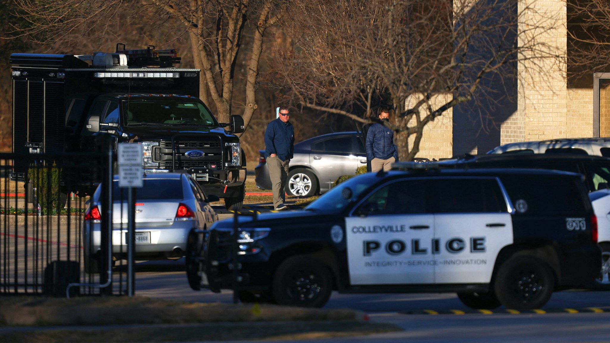 A Police car sits in front of the Congregation Beth Israel Synagogue in Colleyville, Texas, some 25 miles (40 kilometers) west of Dallas, on January 16, 2022. - All four people taken hostage in a more than 10-hour standoff at the Texas synagogue have been freed unharmed, police said late January 15, and their suspected captor is dead.