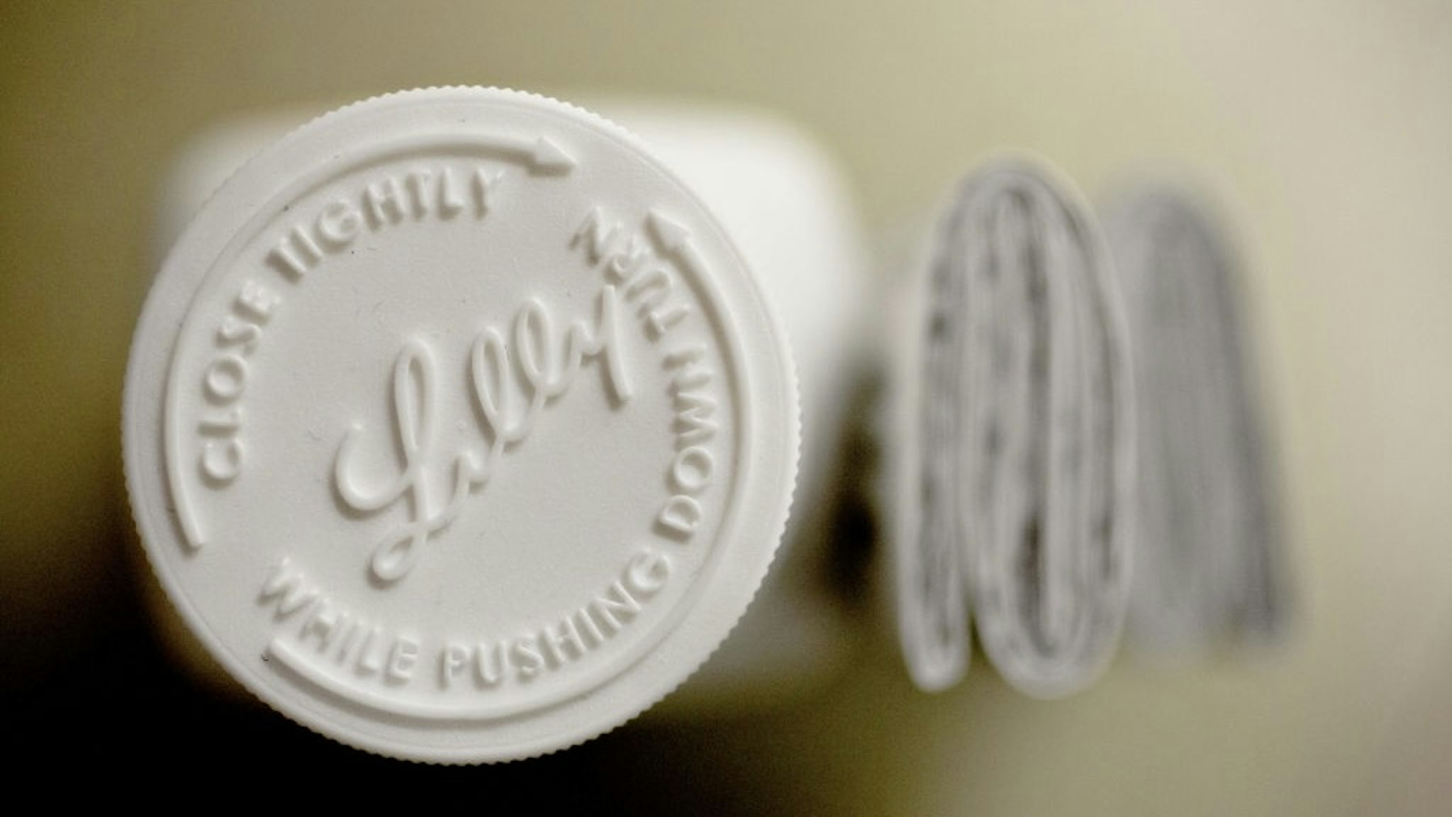 Eli Lilly & Co. Products Ahead Of Earnings Figures An Eli Lilly & Co. logo is seen on the cap of a pill bottle in this arranged photograph at a pharmacy in Princeton, Illinois, U.S., on Monday, Oct. 23, 2017. Eli Lilly is scheduled to release earnings figures on October 24. Photographer: Daniel Acker/Bloomberg via Getty Images Bloomberg / Contributor via Getty Images