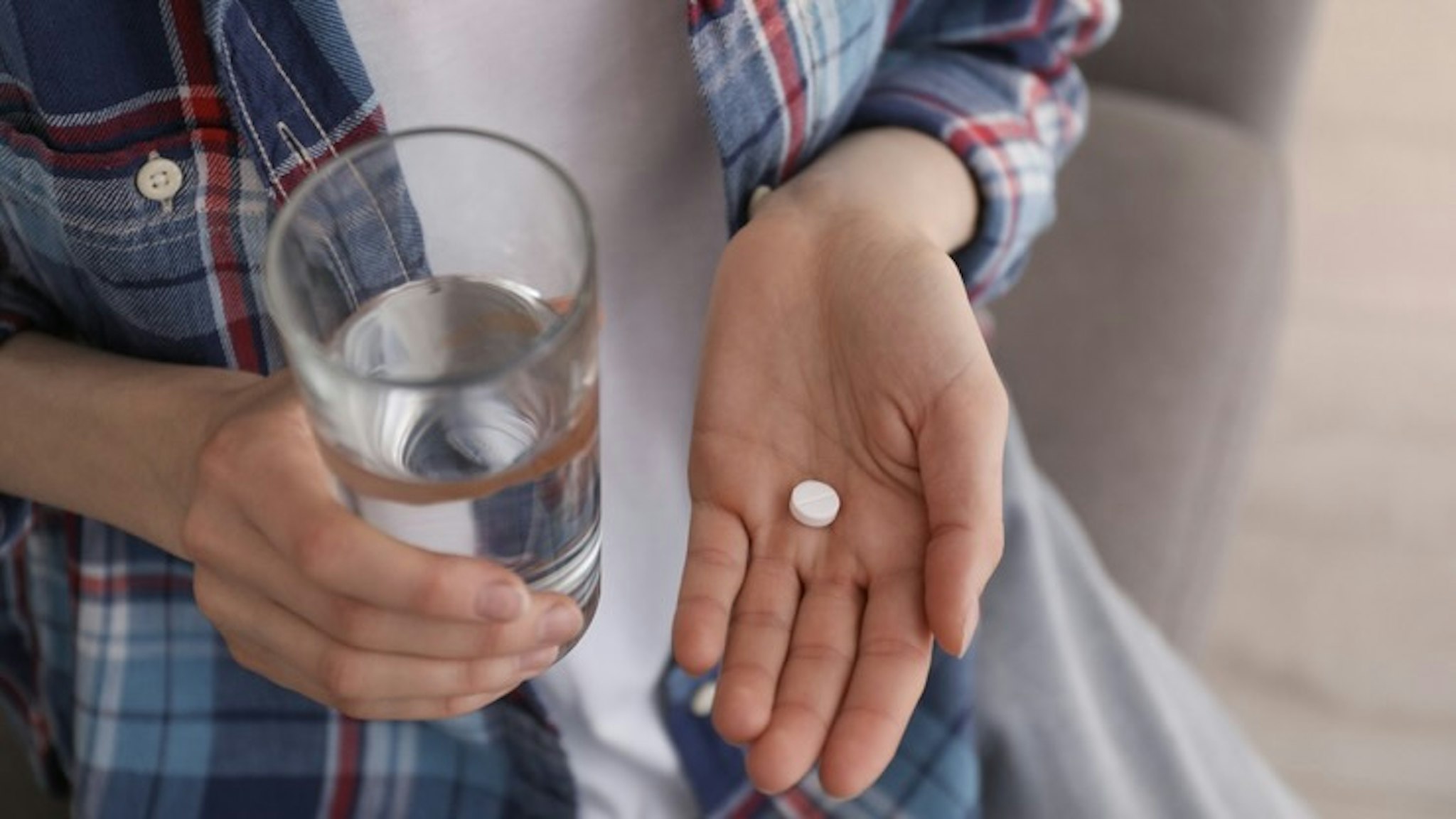 Young woman with abortion pill and glass of water indoors, closeup - stock photo Young woman with abortion pill and glass of water indoors, closeup Liudmila Chernetska via Getty Images