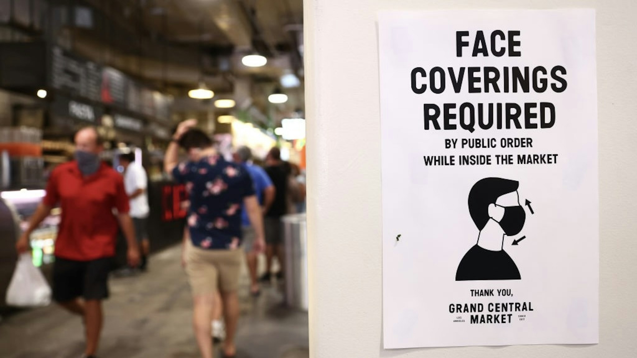 Los Angeles County Makes Masks Mandatory Again Inside As COVID Cases Rise LOS ANGELES, CALIFORNIA - JULY 19: A sign is posted about required face coverings in Grand Central Market on July 19, 2021 in Los Angeles, California. A new mask mandate went into effect just before midnight on July 17th in Los Angeles County requiring all people, regardless of vaccination status, to wear a face covering in public indoor spaces amid a troubling rise in COVID-19 cases. (Photo by Mario Tama/Getty Images) Mario Tama / Staff