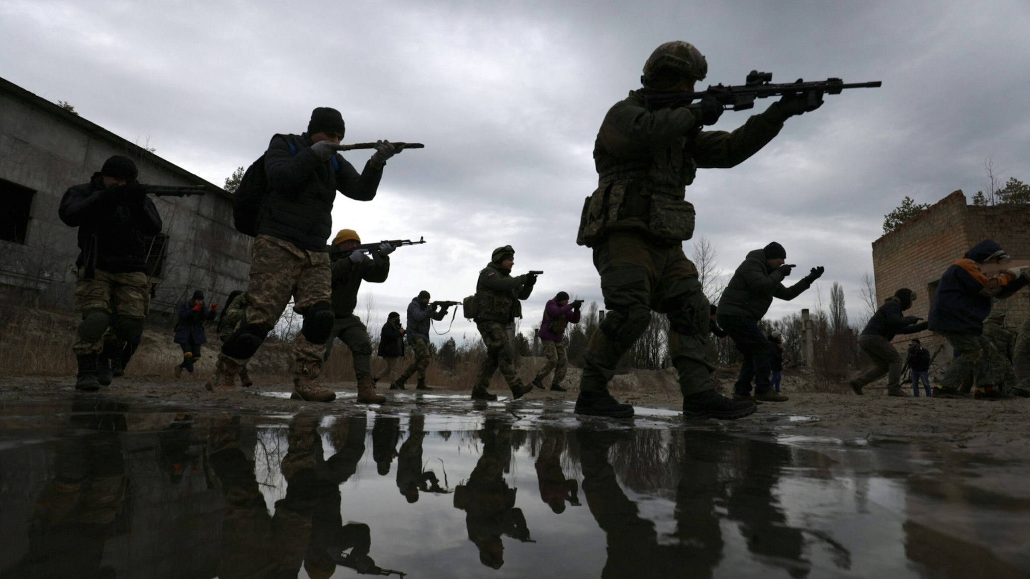 Members of Ukraine's Territorial Defense Forces participate in a drill during training at a former asphalt factory on the outskirts of Kyiv, Ukraine, on Saturday, Feb. 19, 2022.