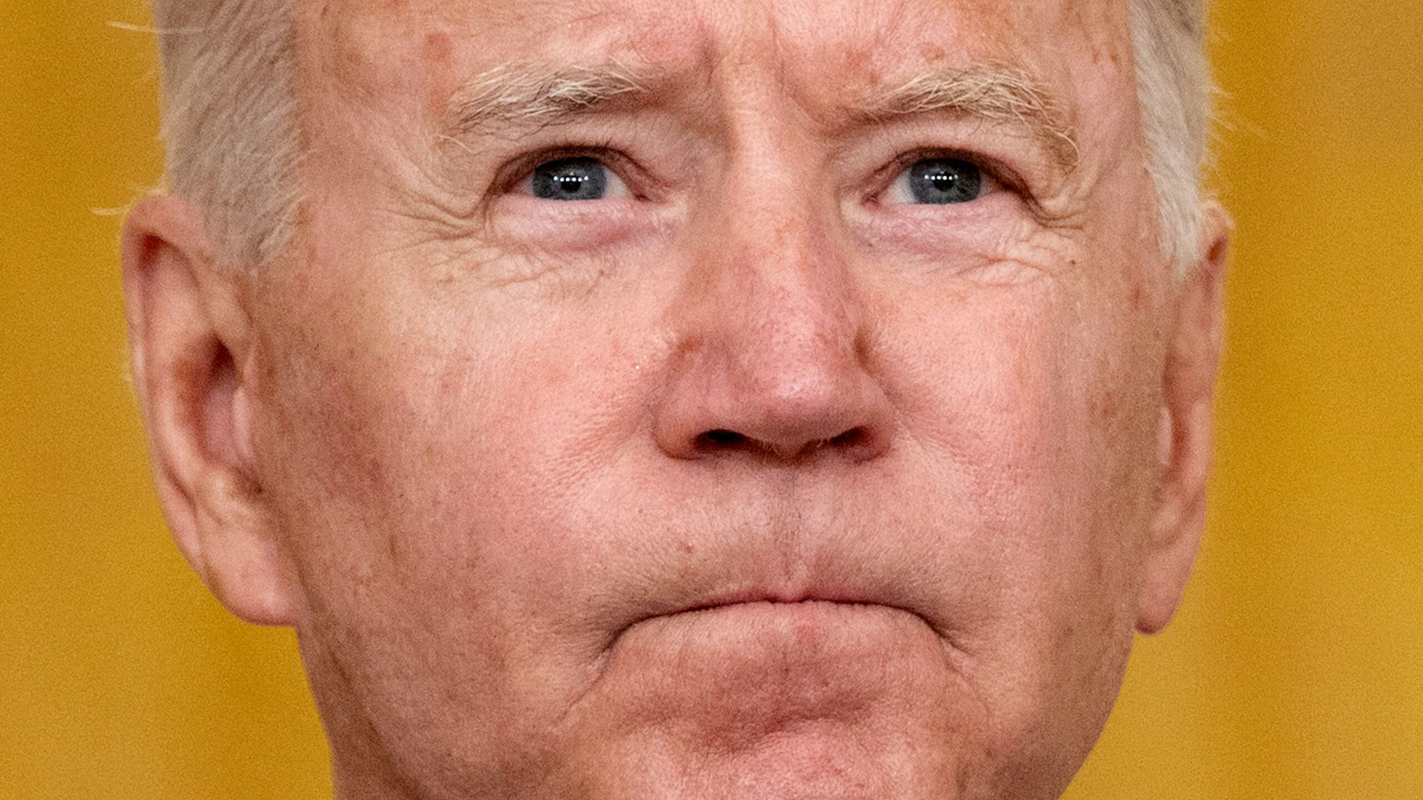 TOPSHOT - US President Joe Biden pauses as he delivers remarks on the terror attack at Hamid Karzai International Airport, and the US service members and Afghan victims killed and wounded, in the East Room of the White House, Washington, DC on August 26, 2021.