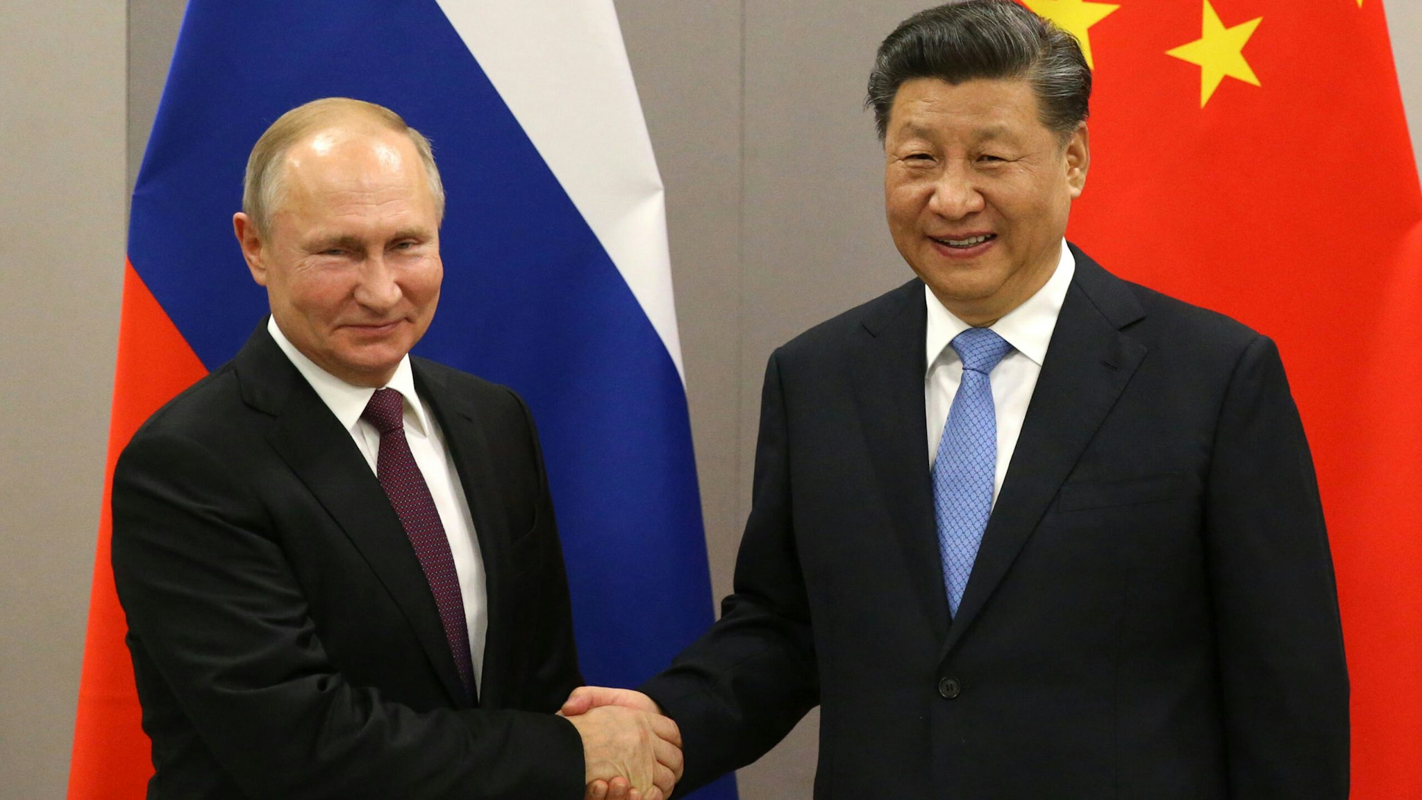 BRASILIA, BRAZIL - NOVEMBER 13: (RUSSIA OUT) Russian President Vladimir Putin (L) greets Chinese President Xi Jinping (R) during their bilateral meeting on November 13, 2019 in Brasilia, Brazil. The leaders of Russia, China, Brazil, India and South Africa have gathered in Brasilia for the BRICS leaders summit.