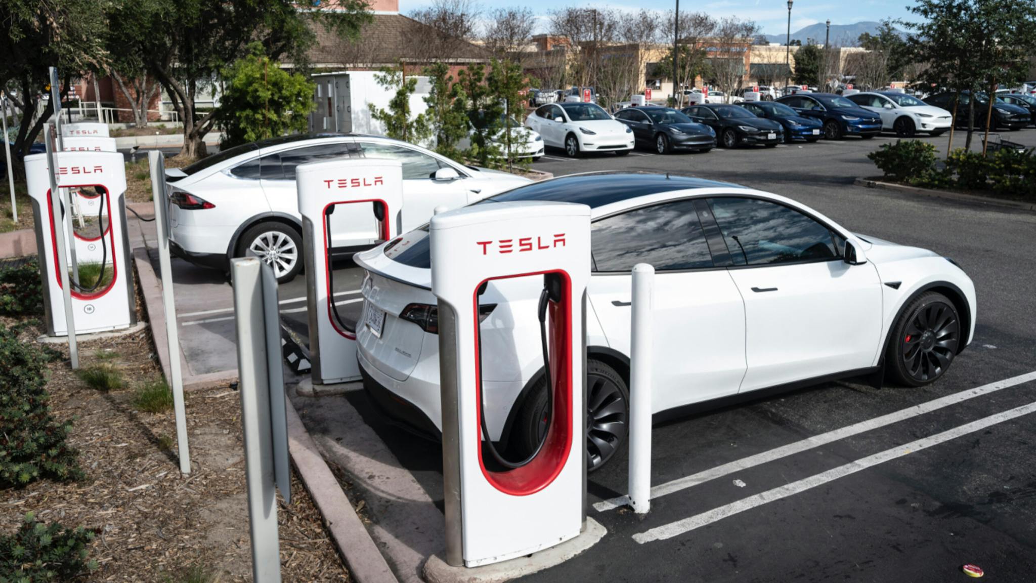 Tesla Tesla cars charge at a Supercharger station on Culver Ave. in Irvine, CA on Friday, January 28, 2022.