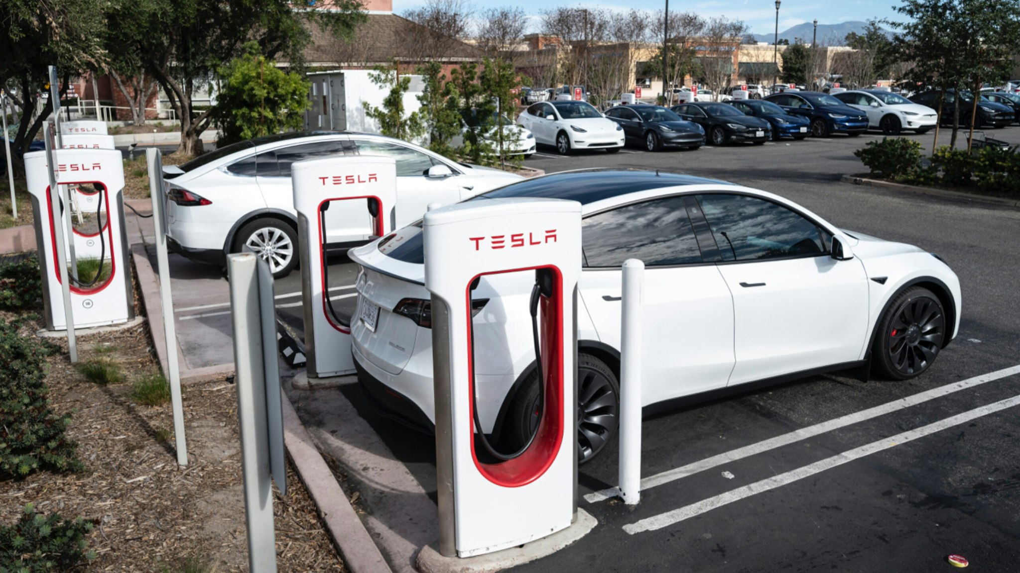 Tesla cars charge at a Supercharger station on Culver Ave. in Irvine, CA on Friday, January 28, 2022.