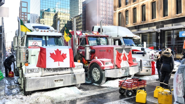 Truckers refuel their trucks in the cold during the Freedom Convoy truck protest on February 5, 2022 in Ottawa, Canada.
