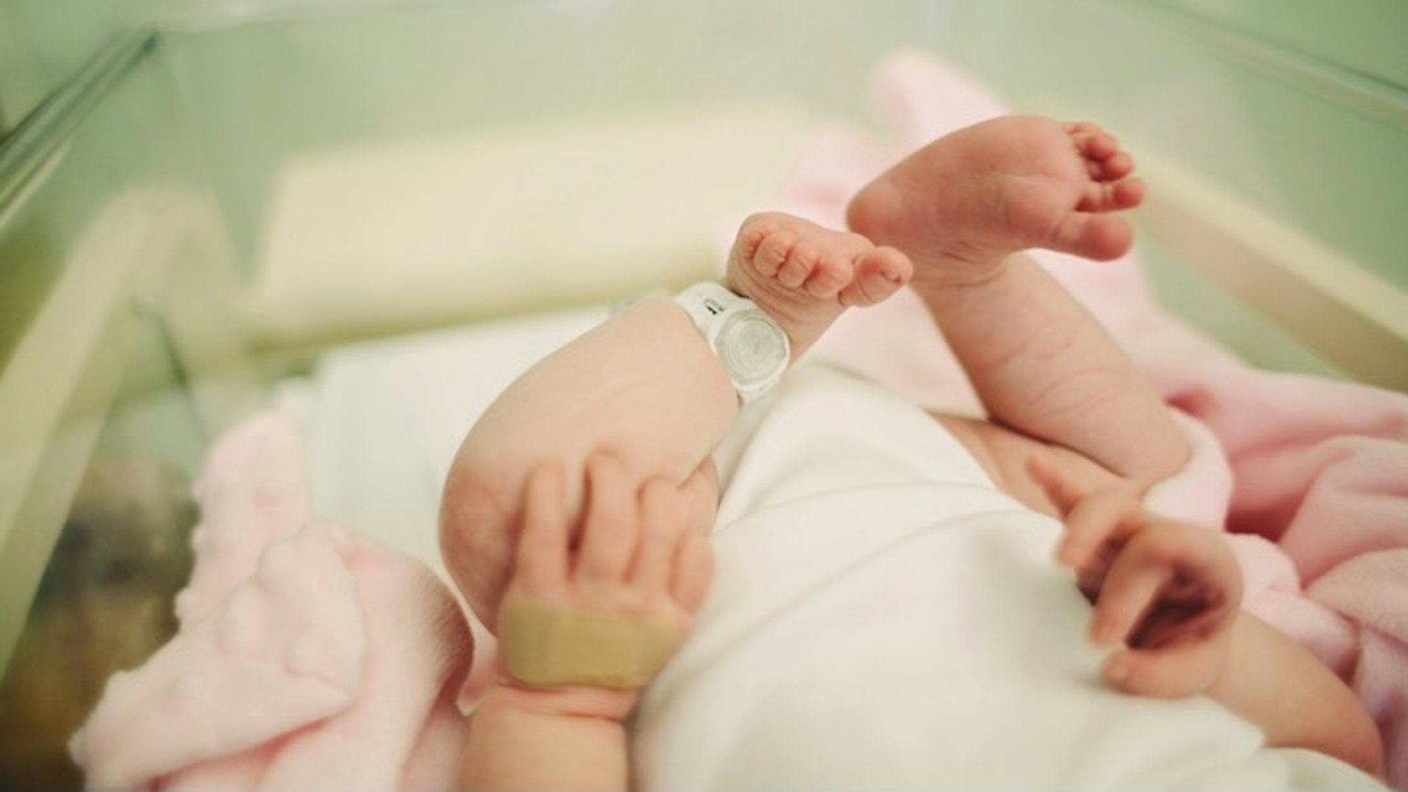 Baby in hospital - stock photo View of baby's feet with a hospital security tag on Sally Anscombe via Getty Images