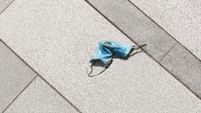 Discarded surgical mask or face mask abandoned on the ground - stock photo Discarded surgical mask Xinzheng via Getty Images