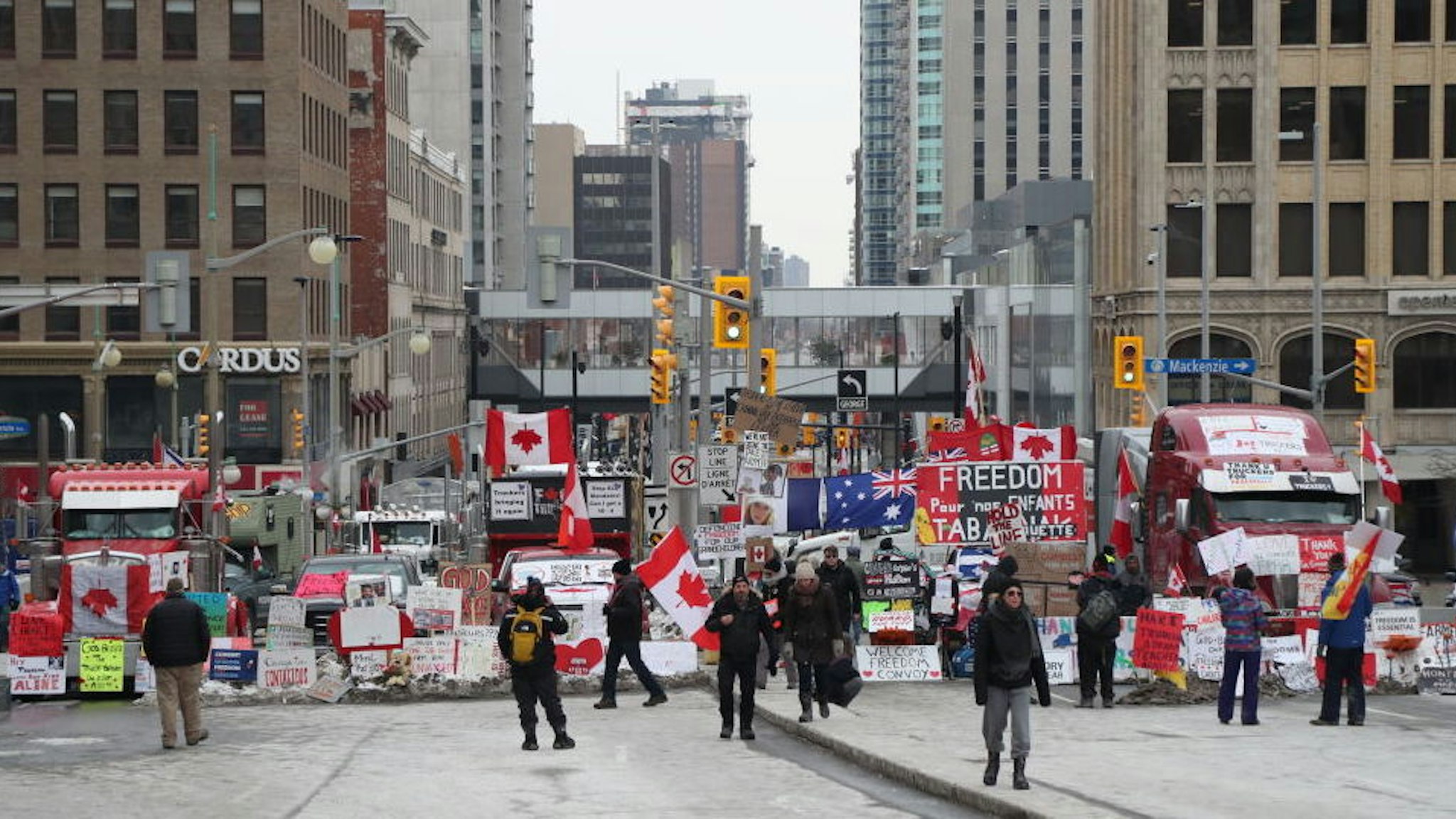 Trucks and protesters block a downtown street during a demonstration in Ottawa, Ontario, Canada, on Wednesday, Feb. 16, 2022. Demonstrations around Ottawa's parliamentary precinct are now prohibited by Prime Minister Trudeau's order, which also instructs banks to cut off funding and services to anyone who is either participating in the blockade or providing support to it. Photographer: