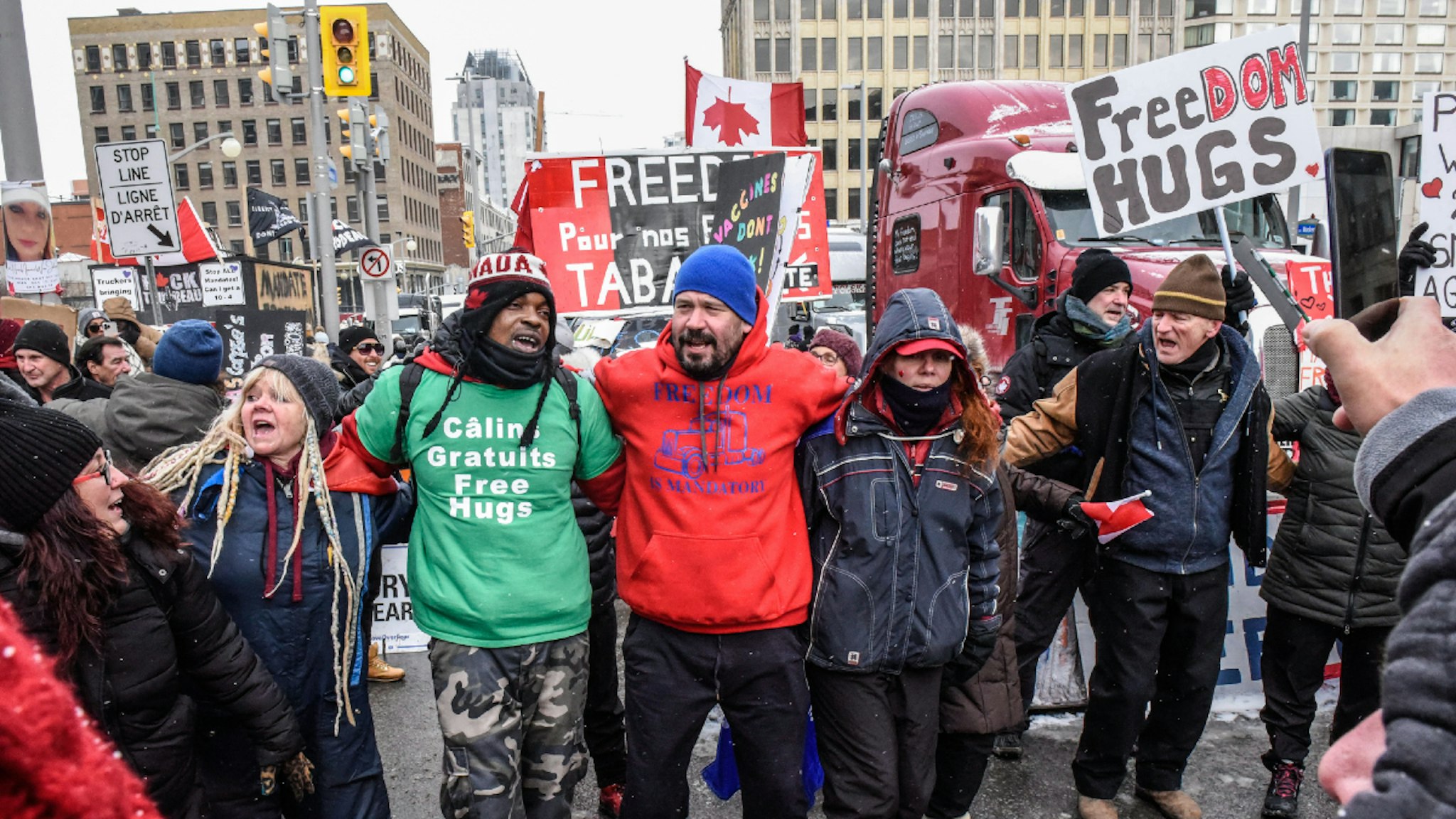 Protesters during a demonstration near Parliament Hill in Ottawa, Ontario, Canada, on Saturday, Feb. 12, 2022. The premier of Canada's biggest province declared a state of emergency, warning protesters choking off traffic at a key U.S. border crossing and causing gridlock in Canada's capital they face stiff punishment if they don't leave.