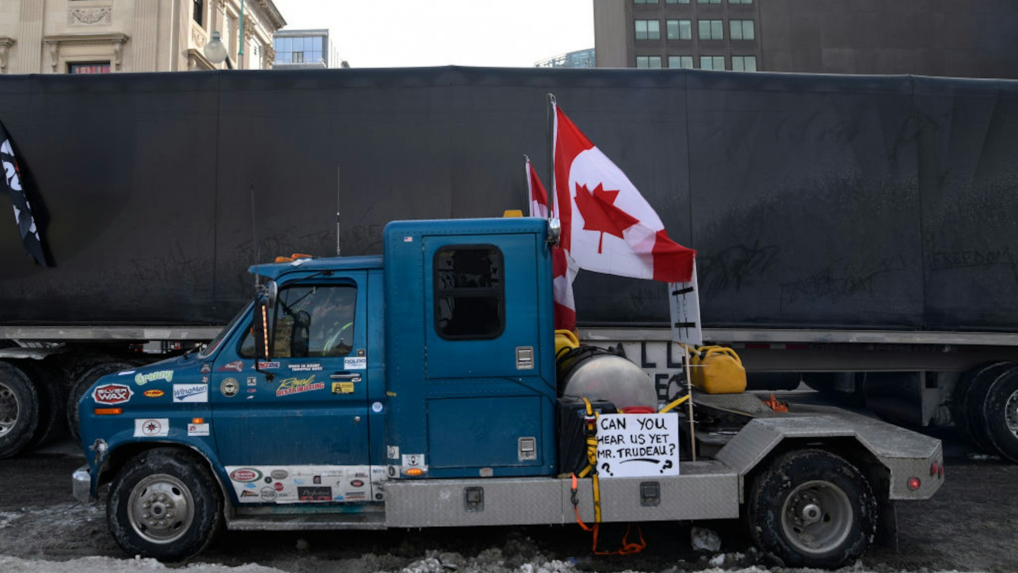 Trucks lined up with banners and signs next to the Parliament building during the 4th Day of Trucker's protest against the mandatory vaccine policy imposed on the Canadian truckers returning from USA to avoid a two week quarantine at Parliament Hill in Ottawa-Canada