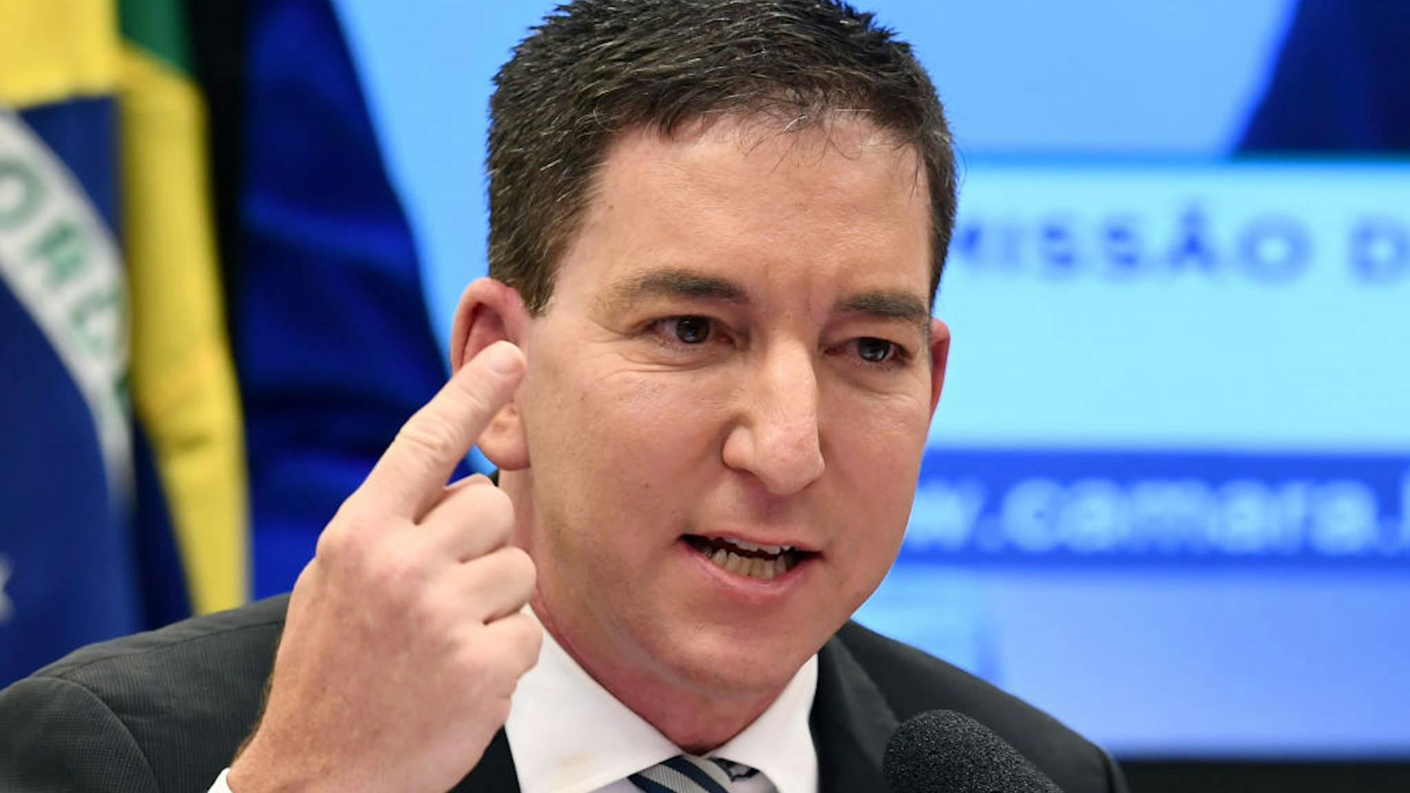BRAZIL-POLITICS-CORRUPTION-INTERCEPT-GREENWALD US journalist Glenn Greenwald, founder and editor of The Intercept website gestures during a hearing at the Lower House's Human Rights Commission in Brasilia, Brazil, on June 25, 2019. - The Intercept has been publishing alleged conversations between Justice Minister and former judge Sergio Moro and prosecutors of Operation Lava Jato, which would have been hacked from their mobile phones. (Photo by EVARISTO SA / AFP) (Photo by EVARISTO SA/AFP via Getty Images)