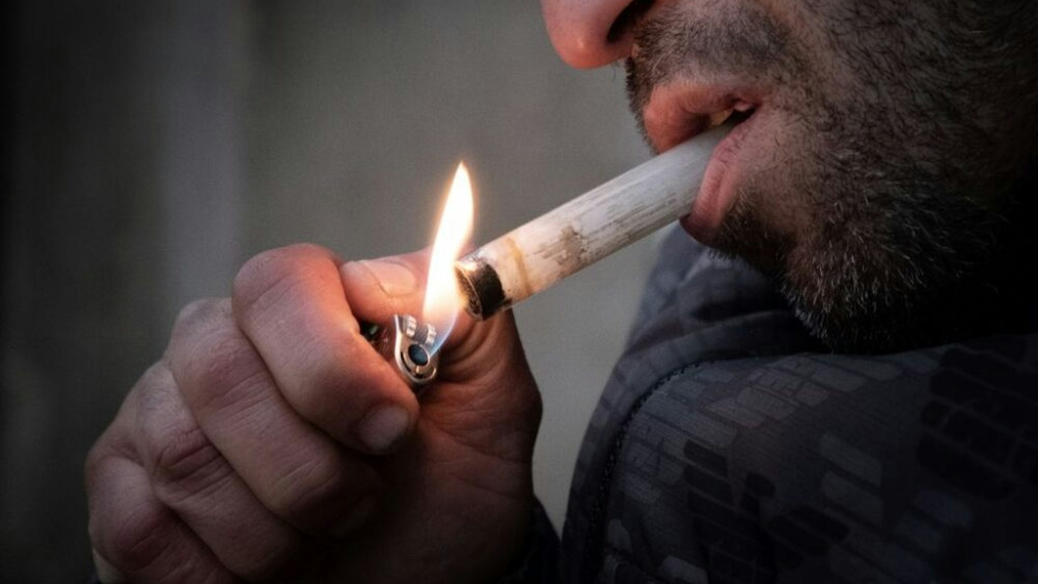 Oussman, a crack addict lights a pipe at Stalingrad Square, nicknamed Stalincrack, on December 2, 2020 in Paris. This "drug of the poor" has been wreaking havoc in the north-east of the capital for thirty years. Over the past 18 months, the authorities have been stepping up initiatives to try to curb the use of this smokable derivative of cocaine: reinforced police patrols, arrests of traffickers, accommodation for drug addicts but these efforts have so far been largely unsuccessful.