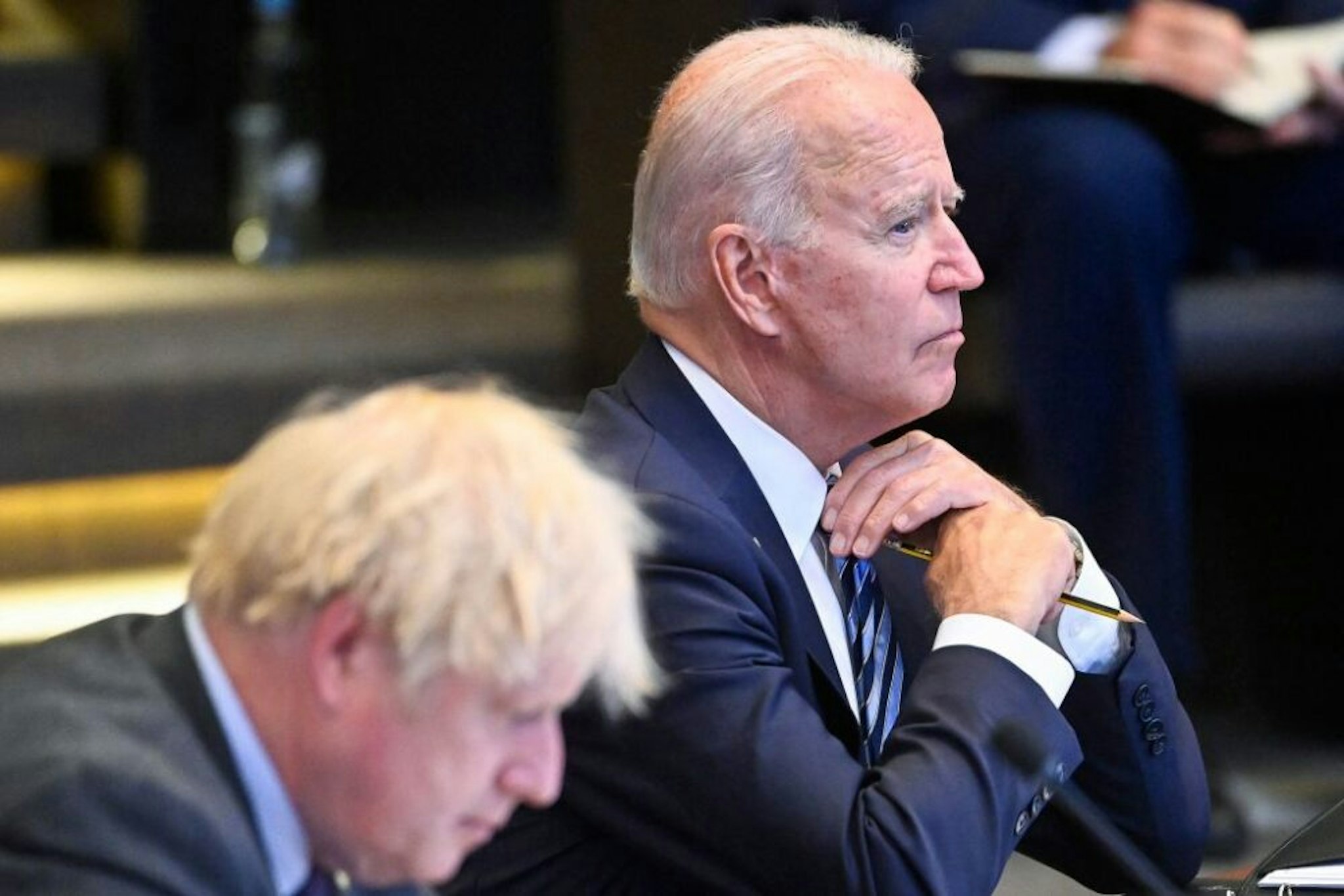 US President Joe Biden (R) and Britain's Prime Minister Boris Johnson (L) attend a plenary session of a NATO summit at the North Atlantic Treaty Organization (NATO) headquarters in Brussels, on June 14, 2021. - The allies will agree a statement stressing common ground on securing their withdrawal from Afghanistan, joint responses to cyber attacks and relations with a rising China. - Belgium OUT