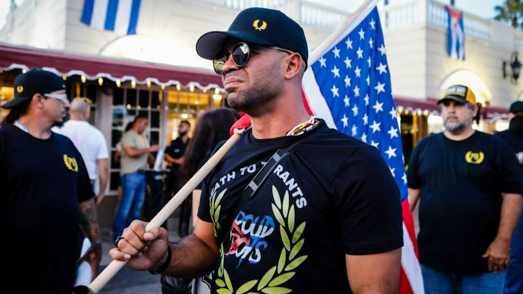 Henry "Enrique" Tarrio, leader of The Proud Boys, holds an US flags during a protest showing support for Cubans demonstrating against their government, in Miami, Florida on July 16, 2021.