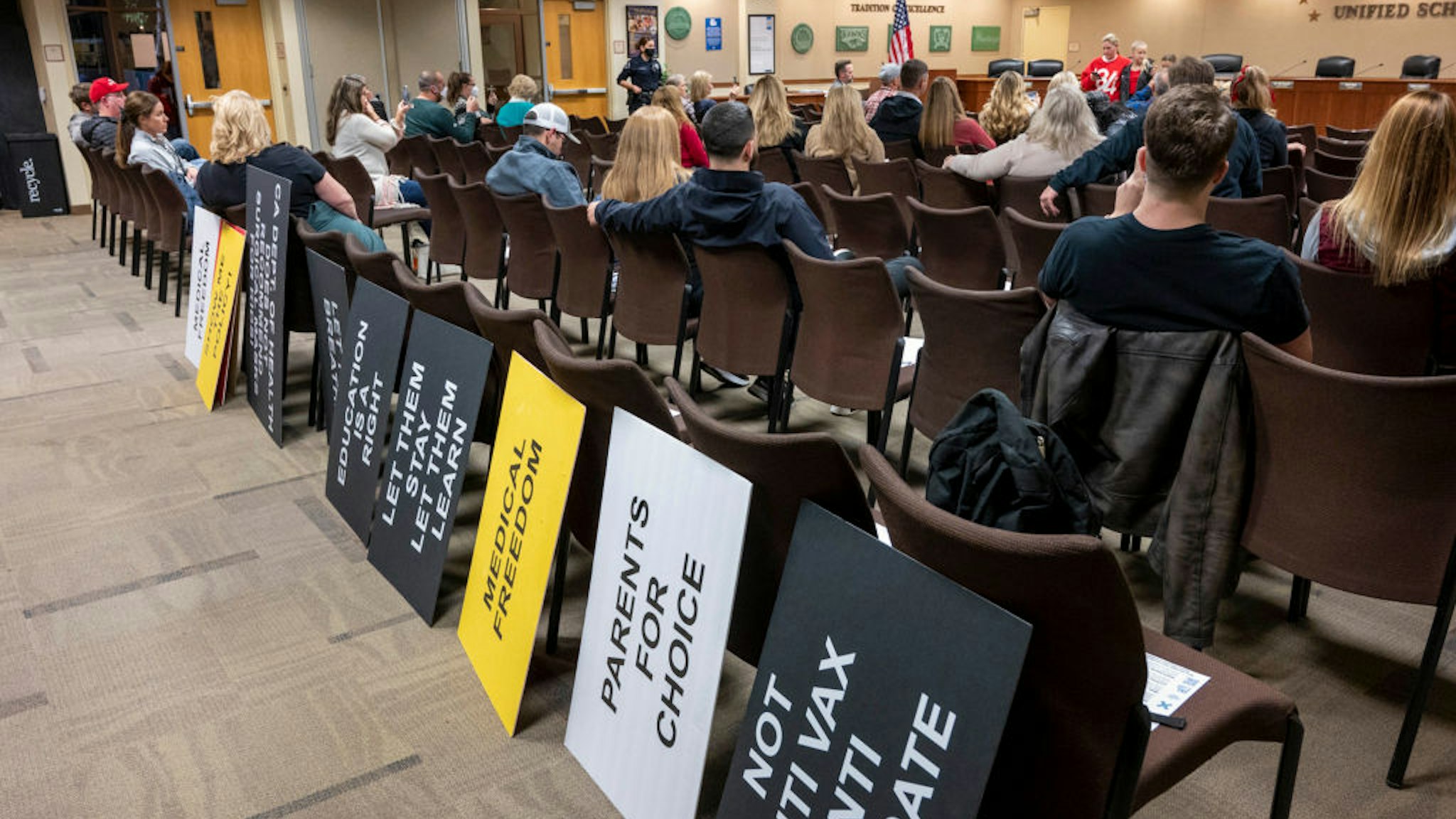 PLACENTIA, CA - JANUARY 19: Protest signs are placed on the back of chairs inside the Placentia-Yorba Linda Unified School District board meeting as parents speak against the mask mandate with trustees Leandra Blades and Shawn Youngblood in an impromptu town hall after board president Carrie Buck canceled the meeting in Placentia on Wednesday, January 19, 2022. The board meeting was also canceled last week after people in the audience refused to wear face masks. (Photo by Leonard Ortiz/MediaNews Group/Orange County Register via Getty Images)