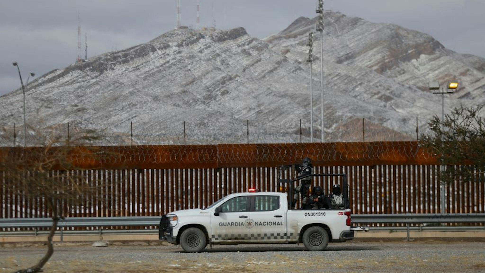 National Guard agents patrol the border wall to prevent migrants from crossing into the United States, after a winter storm in Ciudad Juarez, Chihuahua state, Mexico on February 3, 2022.