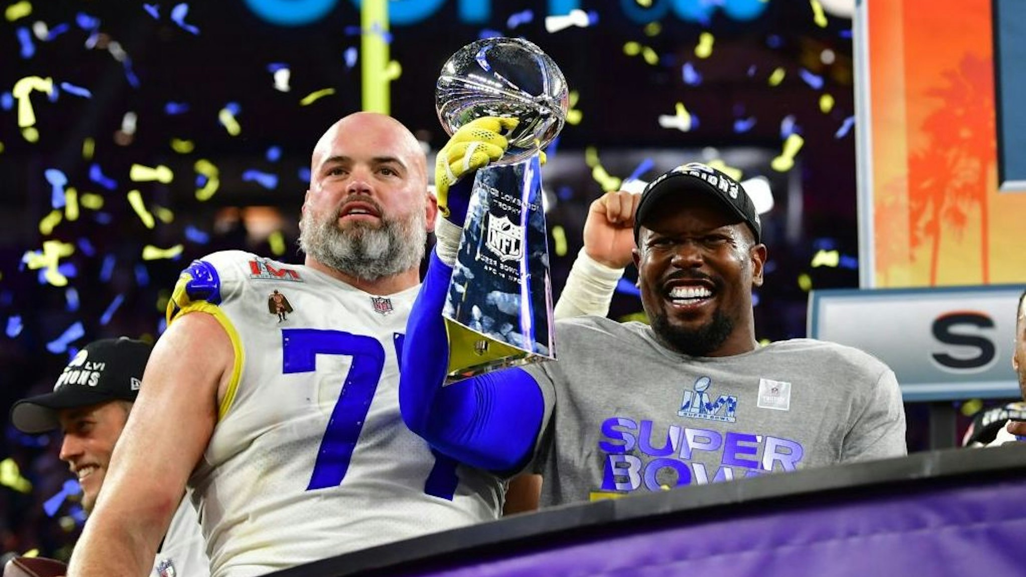 TOPSHOT - Los Angeles Rams' Andrew Whitworth (L) and Los Angeles Rams' Von Miller (R) hold the Vince Lombardi trophy after the LA Rams won Super Bowl LVI against the Cincinnati Bengals at SoFi Stadium in Inglewood, California, on February 13, 2022. (Photo by Frederic J. Brown / AFP) (Photo by FREDERIC J. BROWN/AFP via Getty Images)