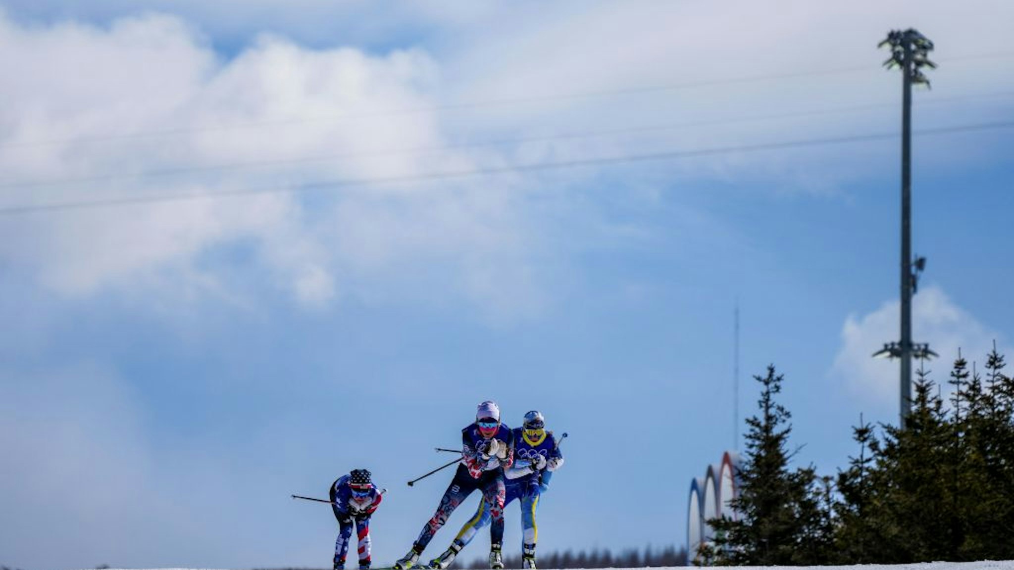 Therese Johaug C of Norway, Ebba Andersson R of Sweden, and Jessie Diggins of the United States compete during the cross-country skiing women's 30km mass start free of Beijing 2022 Winter Olympics at National Cross-Country Skiing Centre in Zhangjiakou, north China's Hebei Province, Feb. 20, 2022. (Photo by Liu Chan/Xinhua via Getty Images)