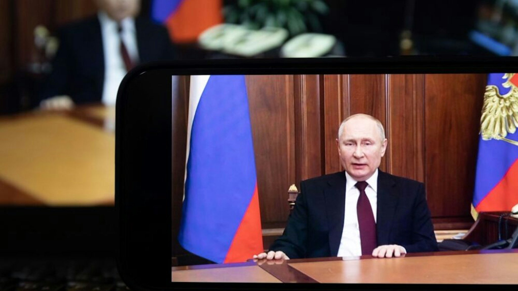 Photo taken on Feb. 21, 2022 shows a screen displaying Russian President Vladimir Putin speaking during a televised address to the nation in Moscow, Russia. Russian President Vladimir Putin announced on Monday that he has signed a decree recognizing "the Lugansk People's Republic LPR" and "the Donetsk People's Republic DPR" as independent and sovereign states.