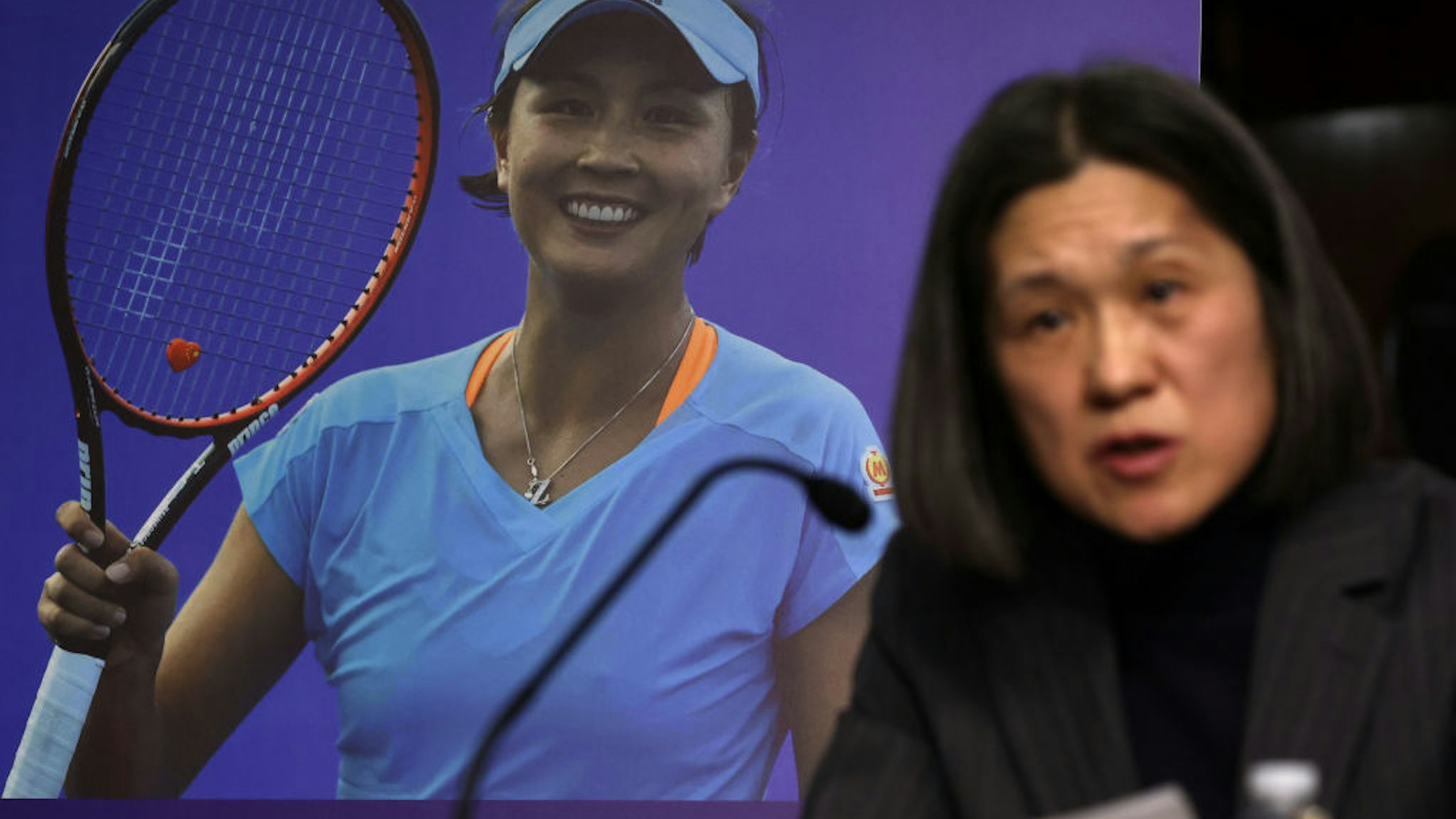 WASHINGTON, DC - FEBRUARY 03: As a photo of Chinese tennis player Peng Shuai is on display in the background, Yaxue Cao, founder and editor of China Change, testifies during a hearing before The Congressional-Executive Commission on China (CECC) at Dirksen Senate Office Building on Capitol Hill on February 3, 2022 in Washington, DC. CECC held a hearing on "The Beijing Olympics and the Faces of Repression." (Photo by Alex Wong/Getty Images)
