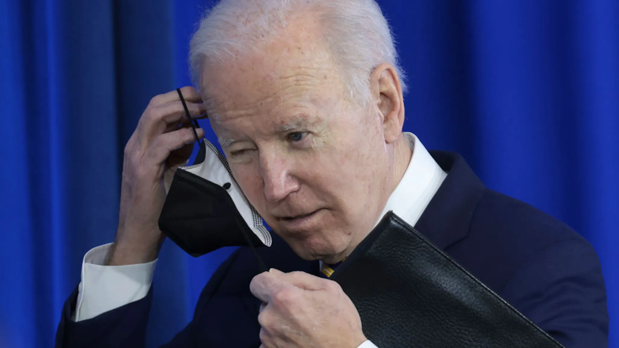 President Biden Delivers Remarks In Virginia On Lowering Health Costs CULPEPER, VIRGINIA - FEBRUARY 10: U.S. President Joe Biden puts on his mask after speaking during an event at Germanna Community College February 10, 2022 in Culpeper. Virginia. During his remarks, Biden highlighted the work his administration has done on lowering health care costs and prescription drug prices. (Photo by Win McNamee/Getty Images)