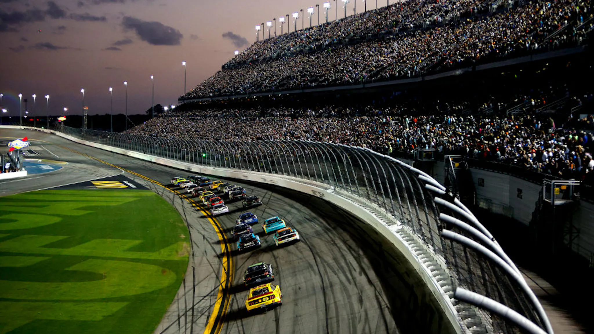 NASCAR Cup Series 64th Annual Daytona 500 DAYTONA BEACH, FLORIDA - FEBRUARY 20: A general view of racing as the sun sets during the NASCAR Cup Series 64th Annual Daytona 500 at Daytona International Speedway on February 20, 2022 in Daytona Beach, Florida.