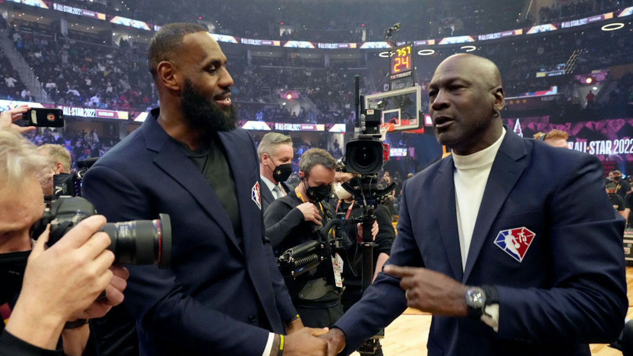 CLEVELAND, OHIO - FEBRUARY 20: (L-R) guest, LeBron James and Michael Jordan attend the 2022 NBA All-Star Game at Rocket Mortgage Fieldhouse on February 20, 2022 in Cleveland, Ohio. NOTE TO USER: User expressly acknowledges and agrees that, by downloading and or using this photograph, User is consenting to the terms and conditions of the Getty Images License Agreement. (Photo by Kevin Mazur/Getty Images)