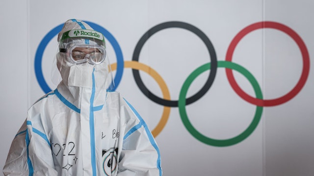 BEIJING, CHINA - FEBRUARY 21: An airport staff member in a hazmat suit works at the Beijing Capital International Airport on February 21, 2022 in Beijing, China. Officials, athletes, and media have started to leave Beijing after the closing ceremony of the Beijing 2022 Winter Olympics. (Photo by Annice Lyn/Getty Images)