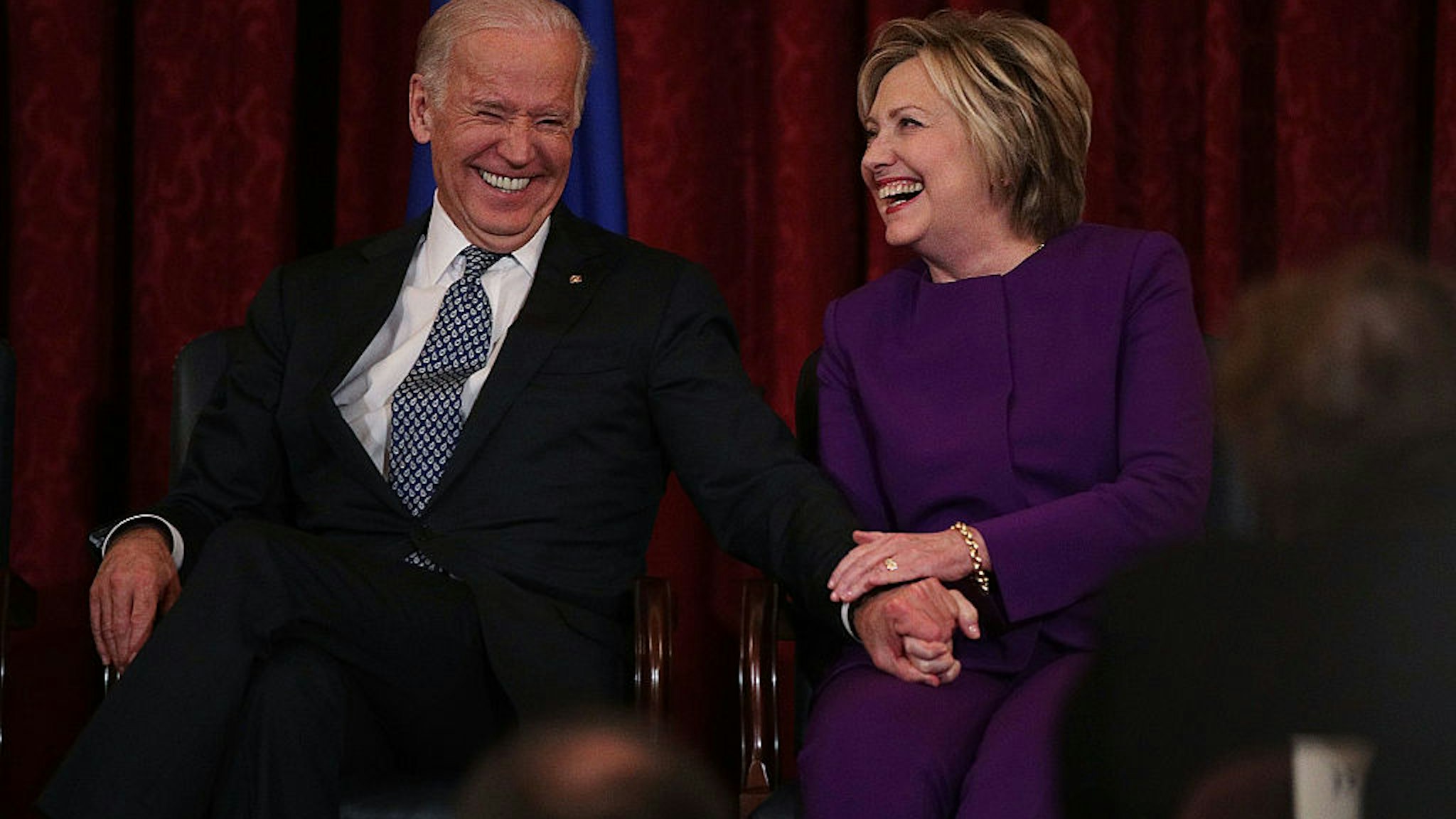WASHINGTON, DC - DECEMBER 08: Former U.S. Secretary of State Hillary Clinton (R) shares a moment with Vice President Joseph Biden (L) during a leadership portrait unveiling ceremony for Senate Minority Leader Sen. Harry Reid (D-NV) December 8, 2016 on Capitol Hill in Washington, DC. The leadership portrait unveiling ceremony was held to honor the outgoing Democratic leader. (Photo by Alex Wong/Getty Images)