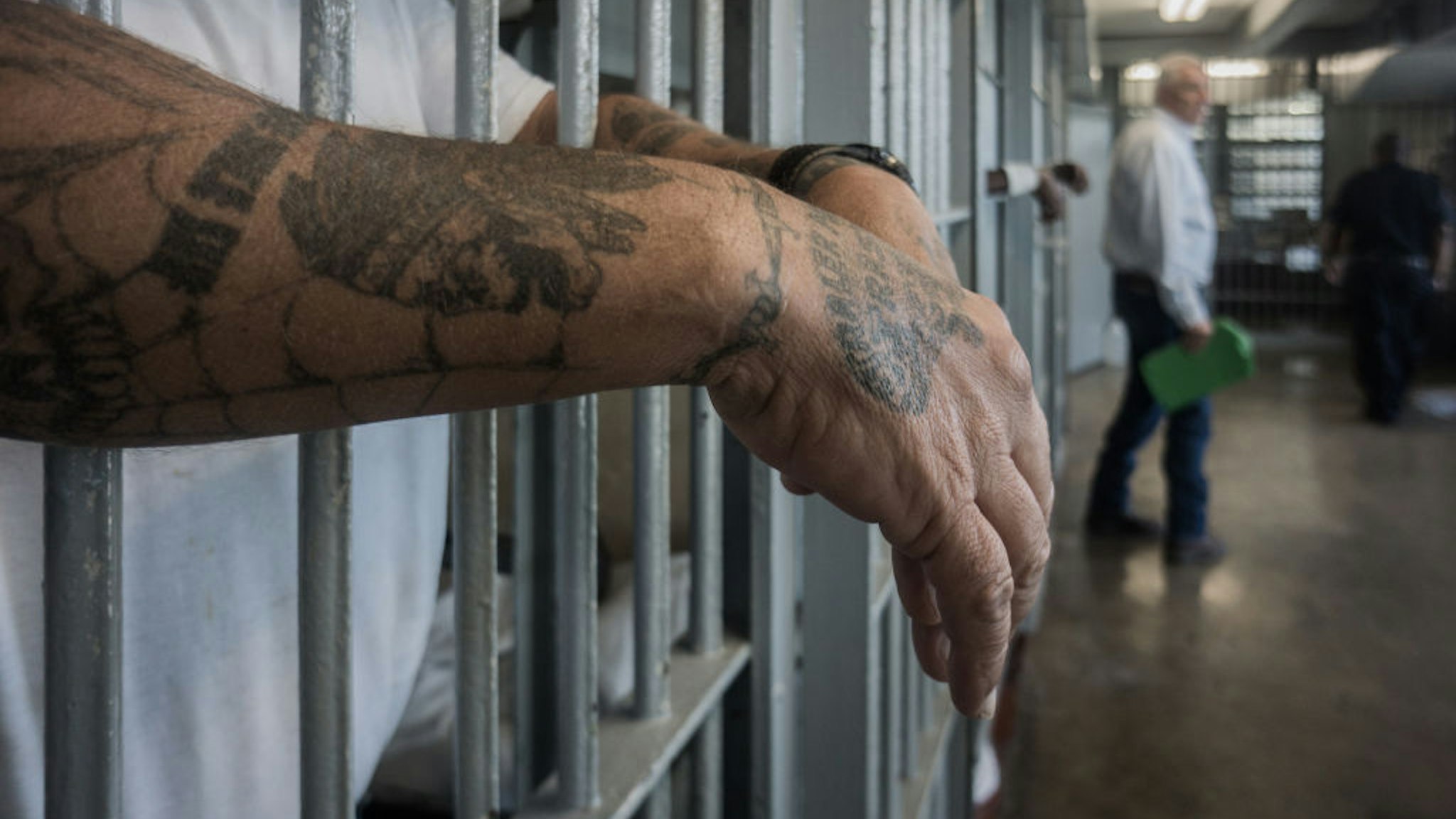 ANGOLA PRISON, LOUISIANA - OCTOBER 14, 2013: A prisoner's hands inside a punishment cell wing at Angola prison. The Louisiana State Penitentiary, also known as Angola, and nicknamed the "Alcatraz of the South" and "The Farm" is a maximum-security prison farm in Louisiana operated by the Louisiana Department of Public Safety &amp; Corrections. It is named Angola after the former plantation that occupied this territory, which was named for the African country that was the origin of many enslaved Africans brought to Louisiana in slavery times. This is the largest maximum-security prison in the United States[with 6,300 prisoners and 1,800 staff, including corrections officers, janitors, maintenance, and wardens. It is located on an 18,000-acre (7,300 ha) property that was previously known as the Angola Plantations and bordered on three sides by the Mississippi River