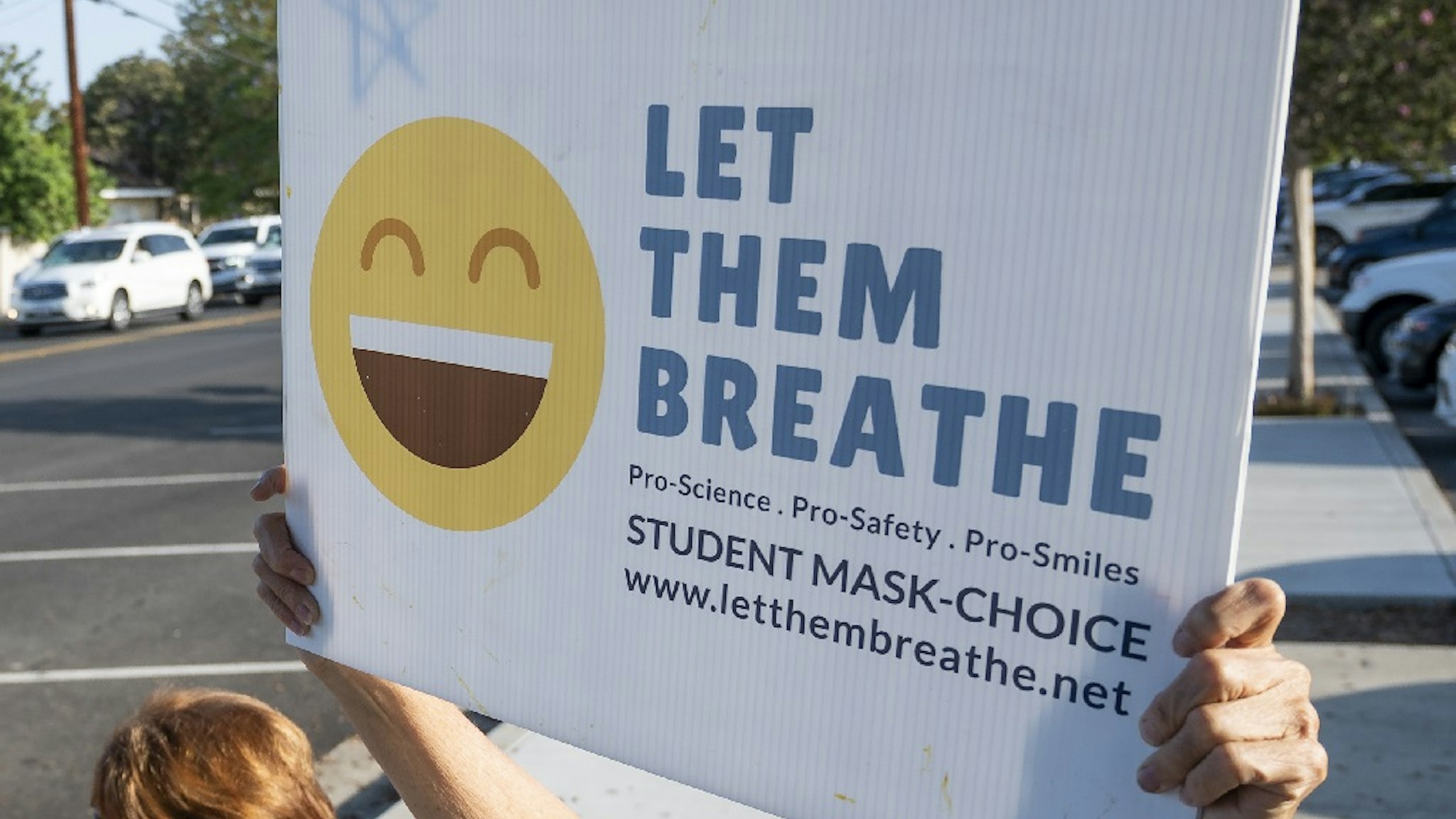Tustin, CA - August 13: Some 30 protesters rallied outside of Hewes Middle School in Tustin, CA on Friday, August 13, 2021, a day after a student refused to wear a face mask on the first day of school and was sent to wait outside the school's front office. 