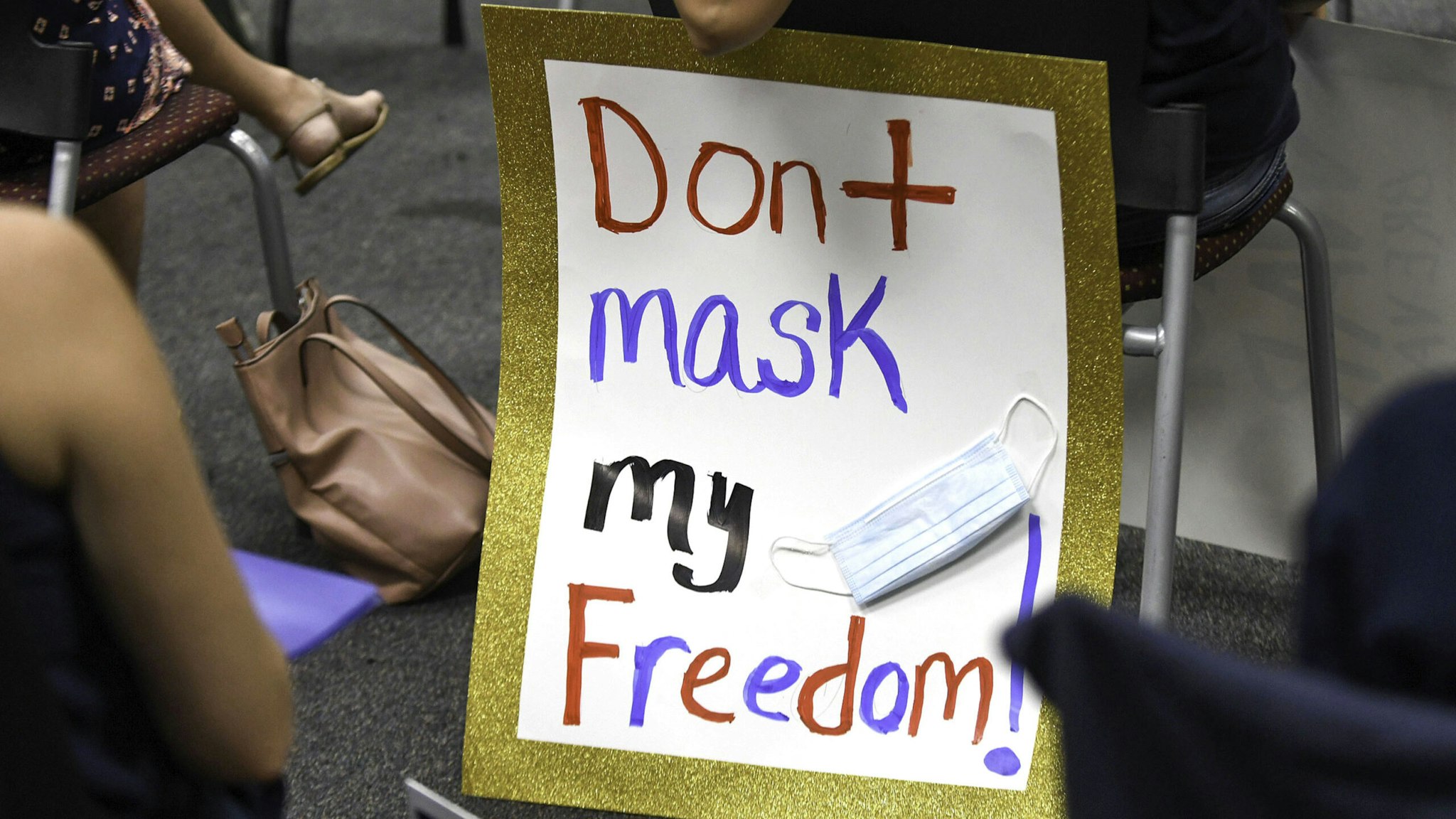 VIERA, FLORIDA, UNITED STATES - 2021/08/30: People demonstrate with placard at an emergency meeting of the Brevard County, Florida School Board in Viera to discuss whether face masks in local schools should be mandatory.