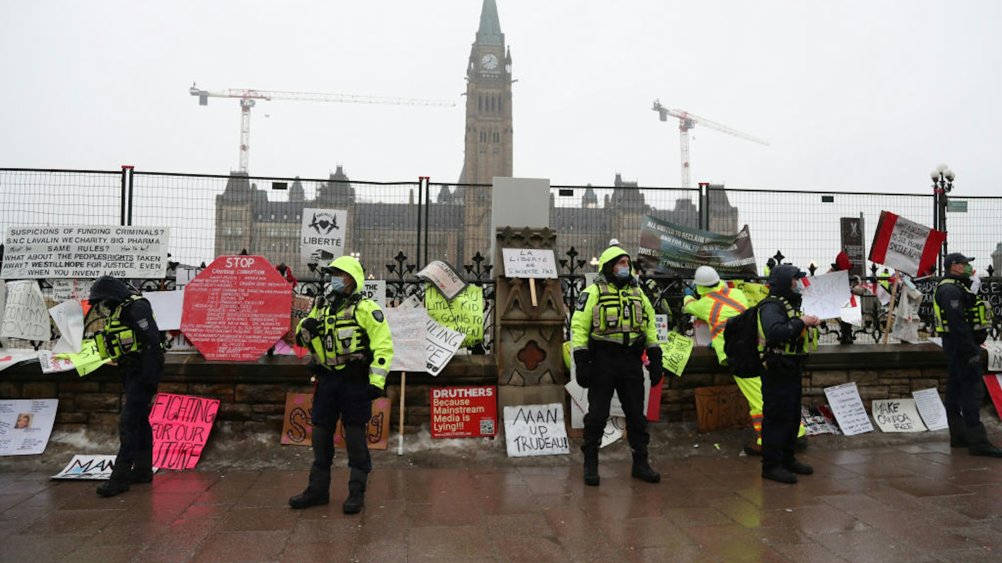 Police officers patrol a street in front of Parliament Hill during a demonstration in Ottawa, Ontario, Canada, on Thursday, Feb. 17, 2022. Police told demonstrators camped out on the streets of Canada's capital that they must leave or be subject to arrest under new emergency powers invoked by Prime Minister Justin Trudeau and Ontario's provincial government. Photographer: David Kawai/Bloomberg