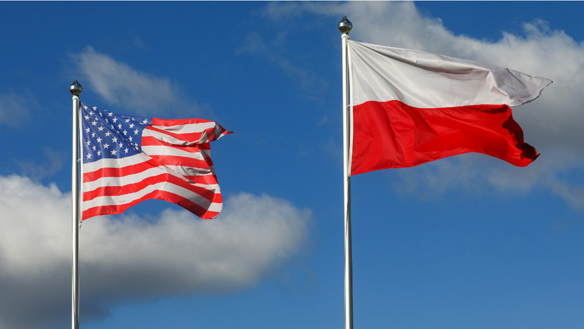 Polish and US national flags are seen at the Mielec Airport. Mielec, Poland on February 12, 2022. US troops have arrived as reinforcements for its various NATO allies in Eastern Europe, including Poland, as fears grow of a possible Russian invasion of Ukraine