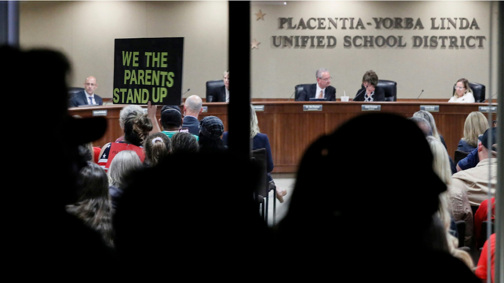 Yorba Linda, CA, Tuesday, November 16, 2021 - Spectators left outside due to a room filled to capacity, watch through a window as the Placentia Yorba Linda School Board discusses a proposed resolution to ban critical race theory from being taught in schools.