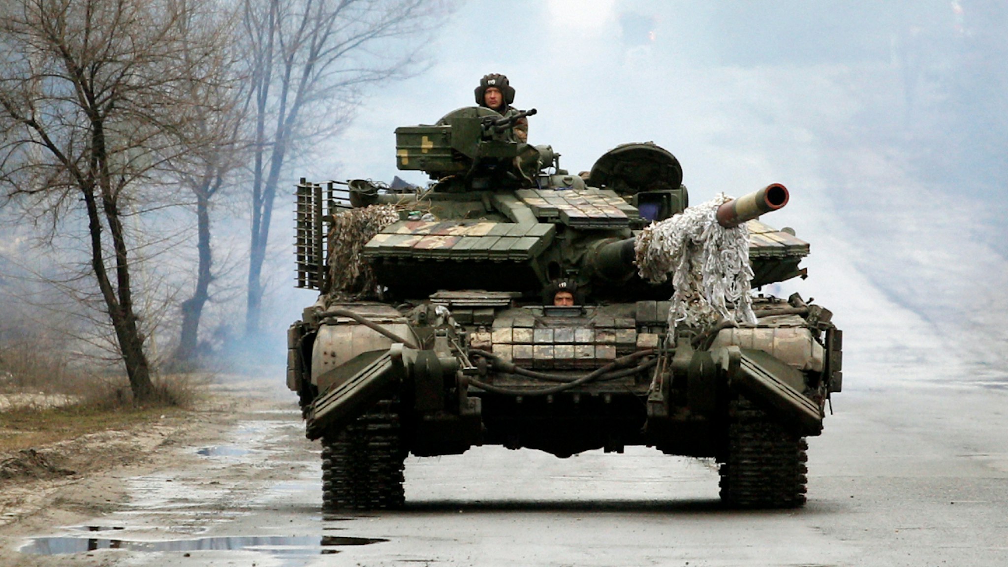 Ukrainian servicemen ride on tanks towards the front line with Russian forces in the Lugansk region of Ukraine on February 25, 2022.