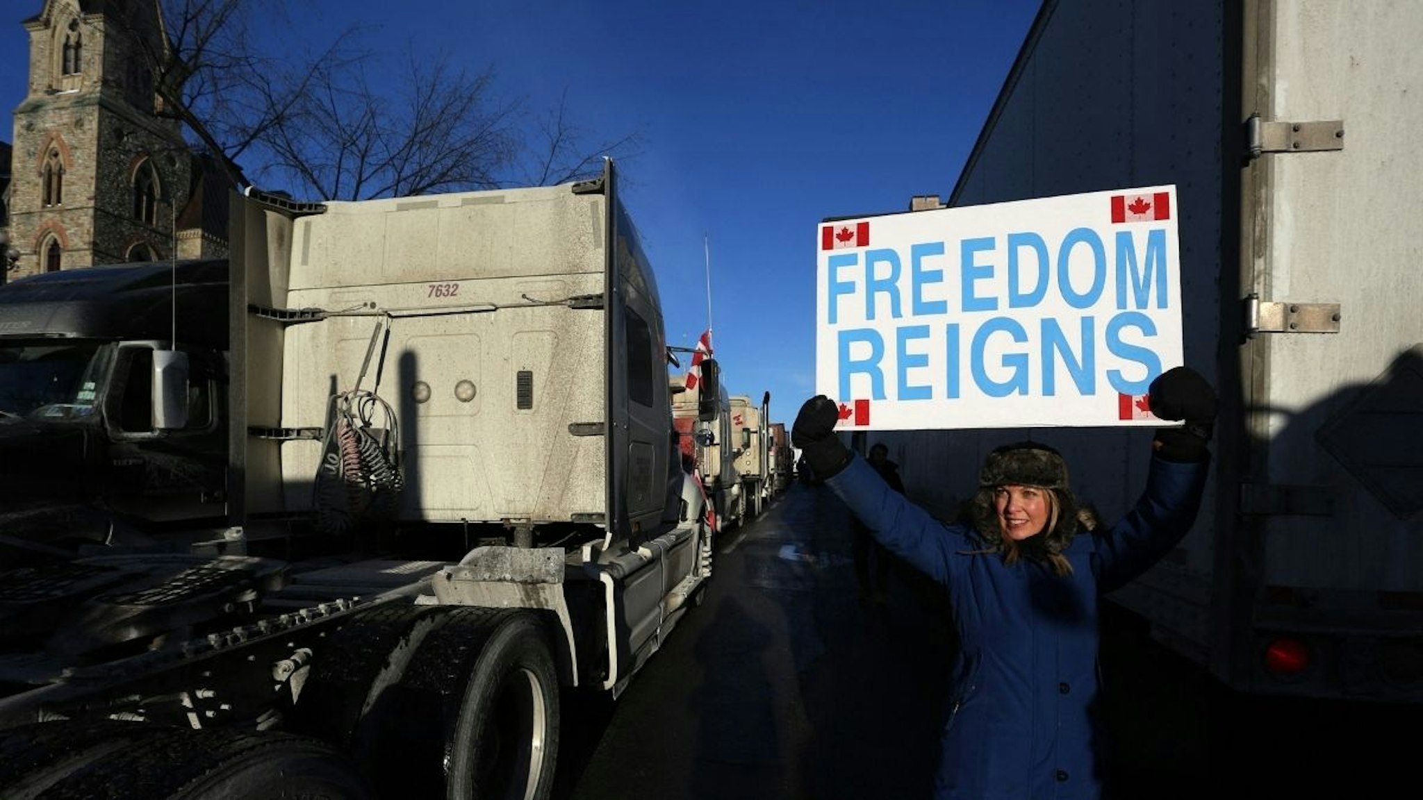 A supporter holds a sign while participating in a "Freedom Convoy" protesting against COVID-19 vaccine mandates and restrictions in front of the Parliament of Canada on January 28, 2022 in Ottawa, Canada.