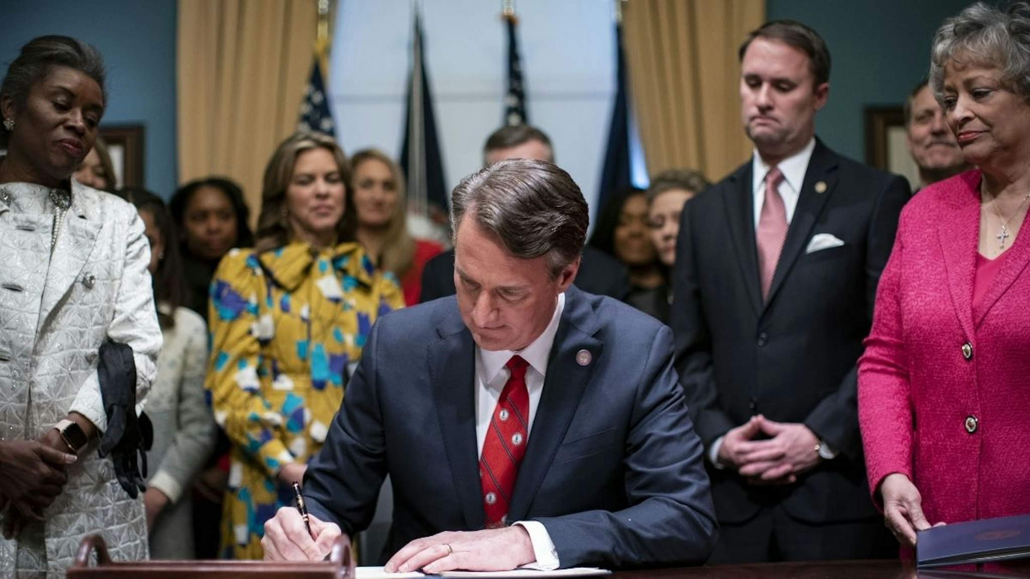 Glenn Youngkin, governor of Virginia, signs executive actions in the Virginia State Capitol in Richmond, Virginia, U.S., on Saturday, Jan. 15, 2022.