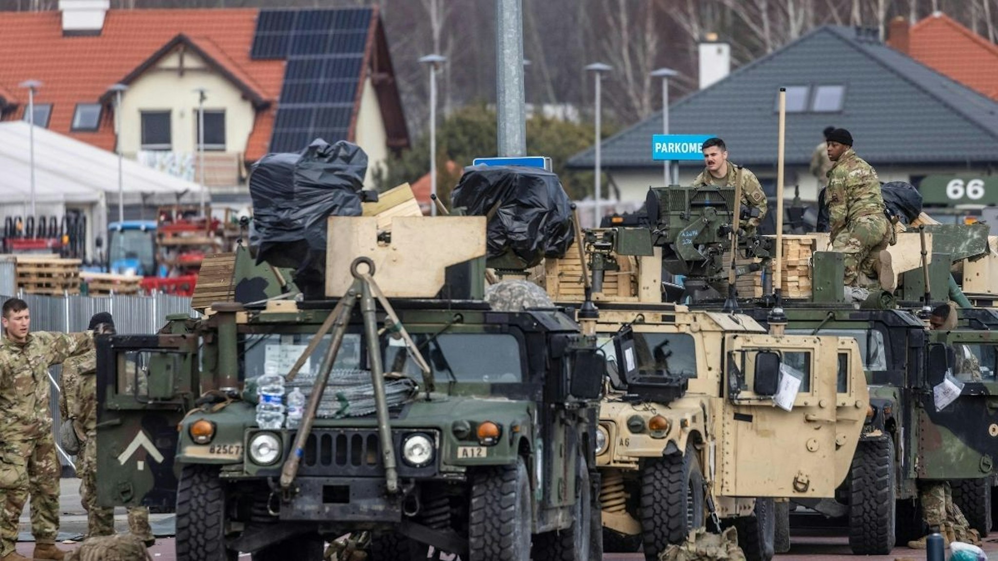US soldiers work on their vehicles at a temporary base installed close to the Rzeszow-Jasionka Airport, south eastern Poland, February 16, 2022.