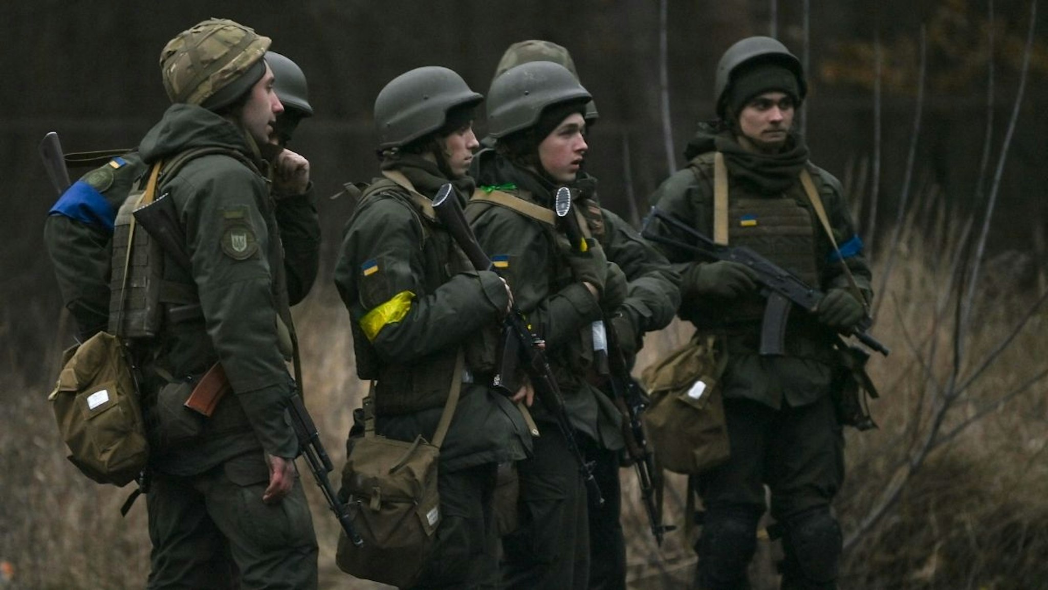 Ukrainian servicemen stand on the north of Kyiv on February 24, 2022.