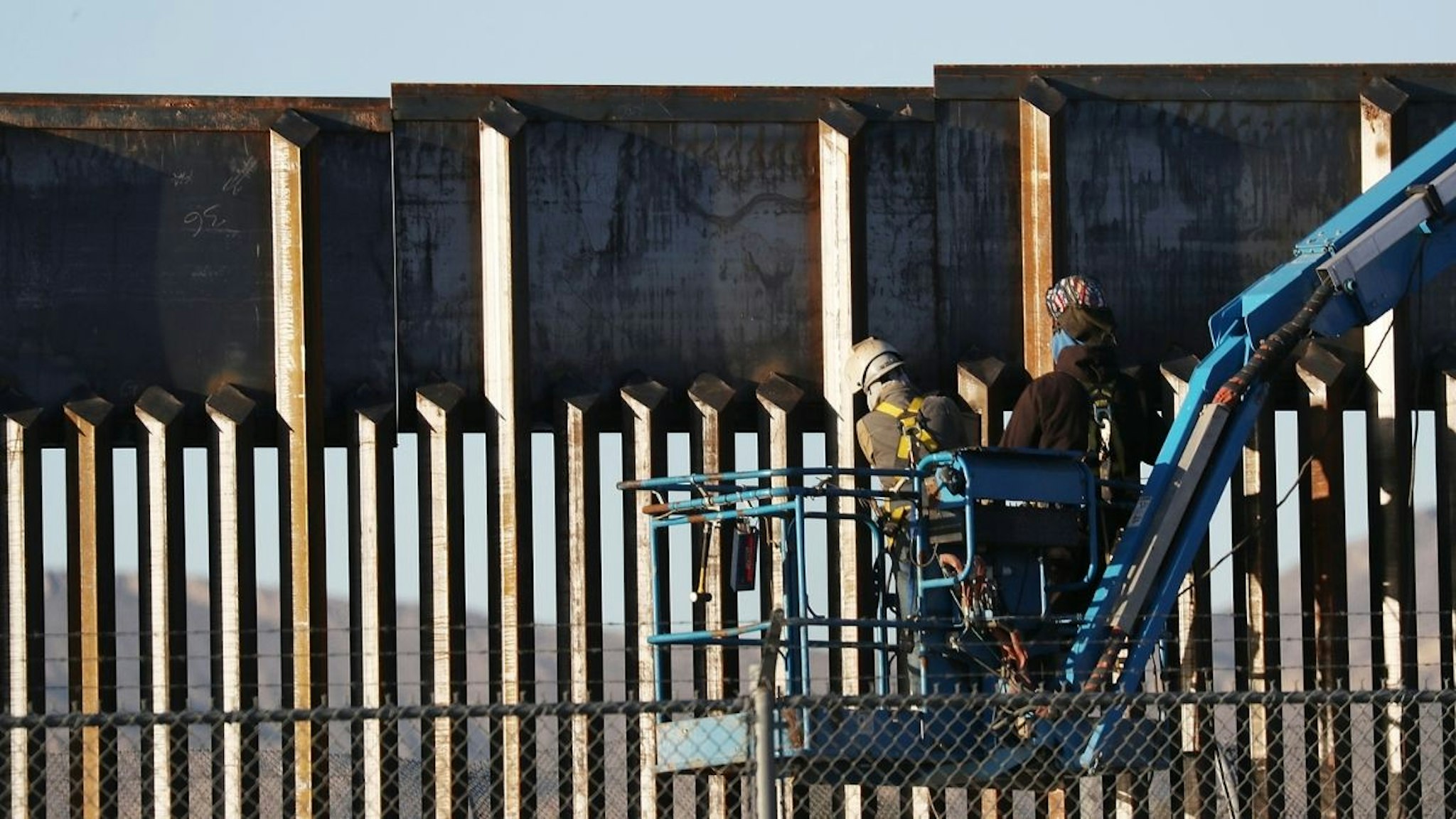 People work on the U.S./ Mexican border wall on February 12, 2019 in El Paso, Texas. U.S.