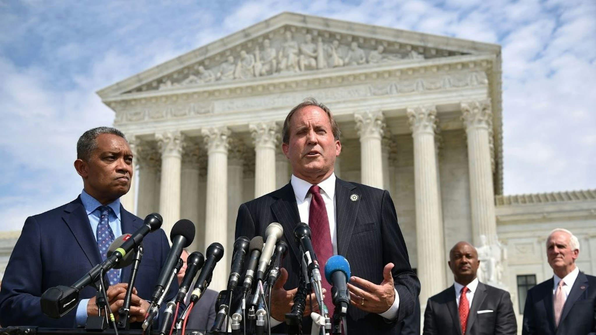 District of Columbia Attorney General Karl Racine (L) and Texas Attorney General Ken Paxton speak during the launch of an antitrust investigation into large tech companies outside of the US Supreme Court in Washington, DC on September 9, 2019.