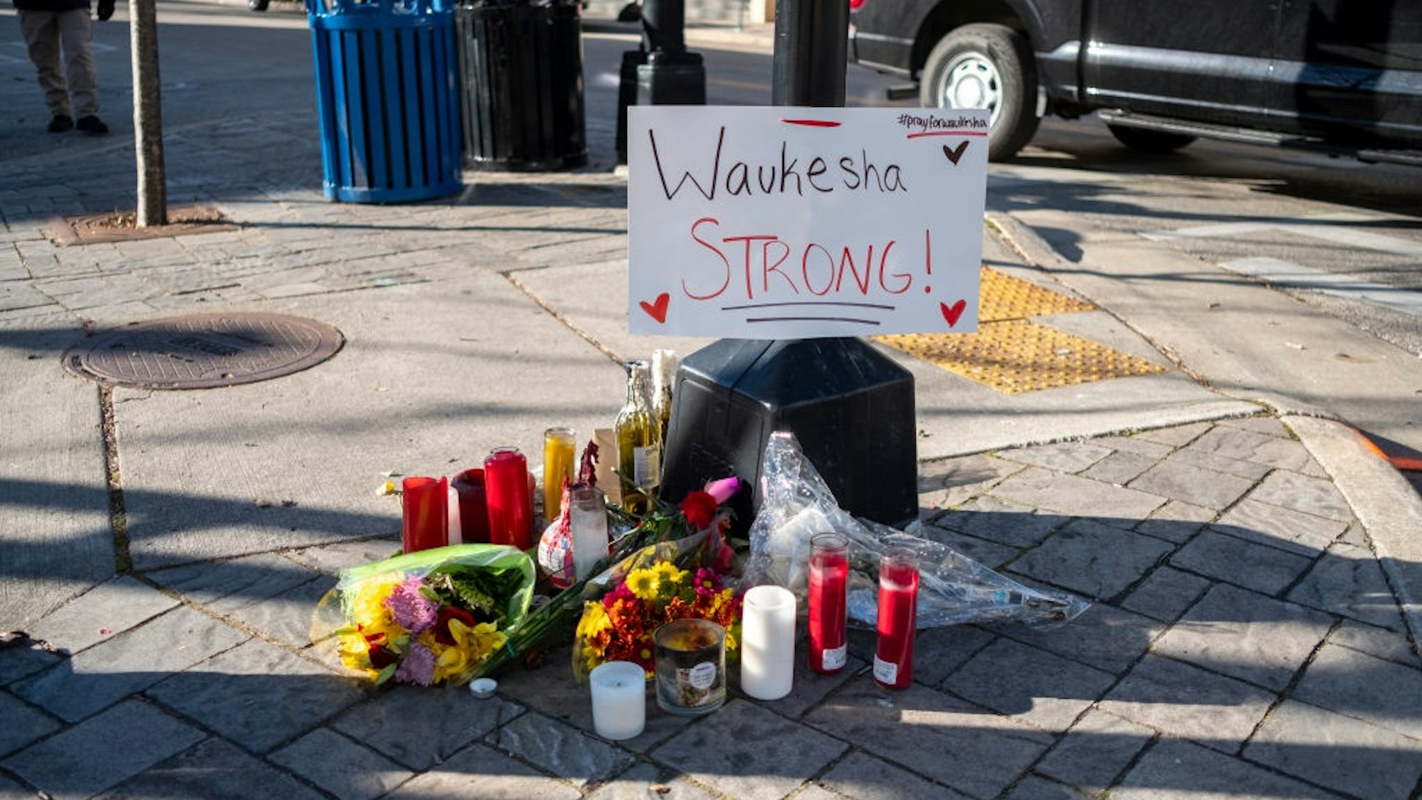WAUKESHA, WI - NOVEMBER 23: Memorials placed along Main Street in downtown Waukesha Wisconsin left in areas where people were hit by a driver plowing into the Christmas parade on Main Street in downtown November 22, 2021 in Waukesha, Wisconsin.